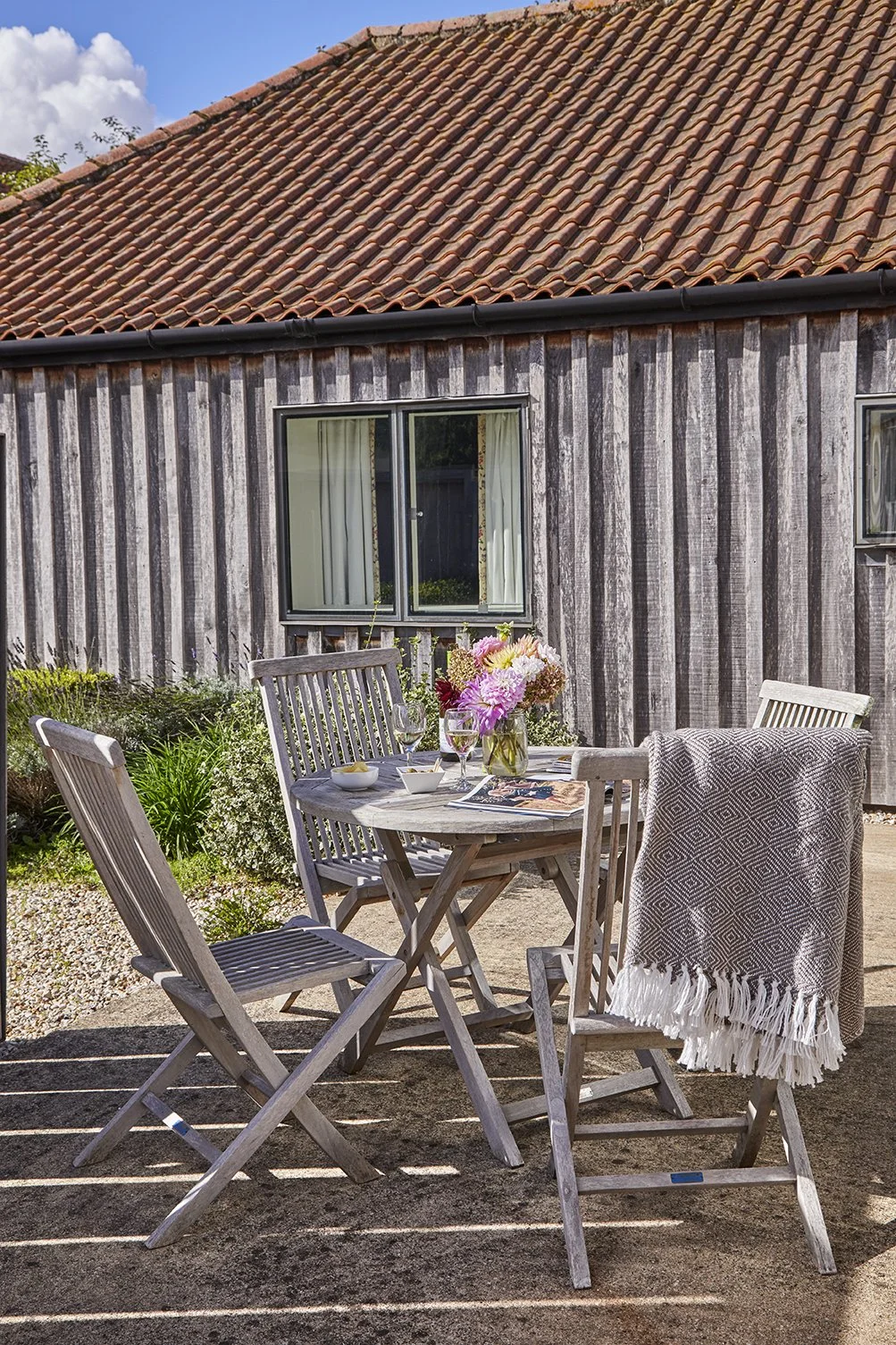 The sunny courtyard garden at Little Barsham with a private seating area