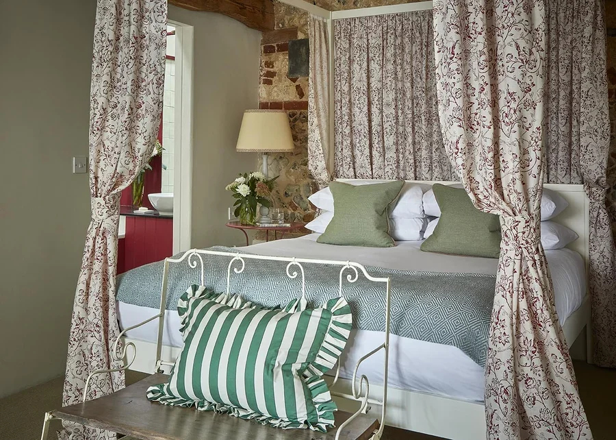 The en-suite Master Bedroom in Greys Court with sumptuous fabrics by Flora Soames