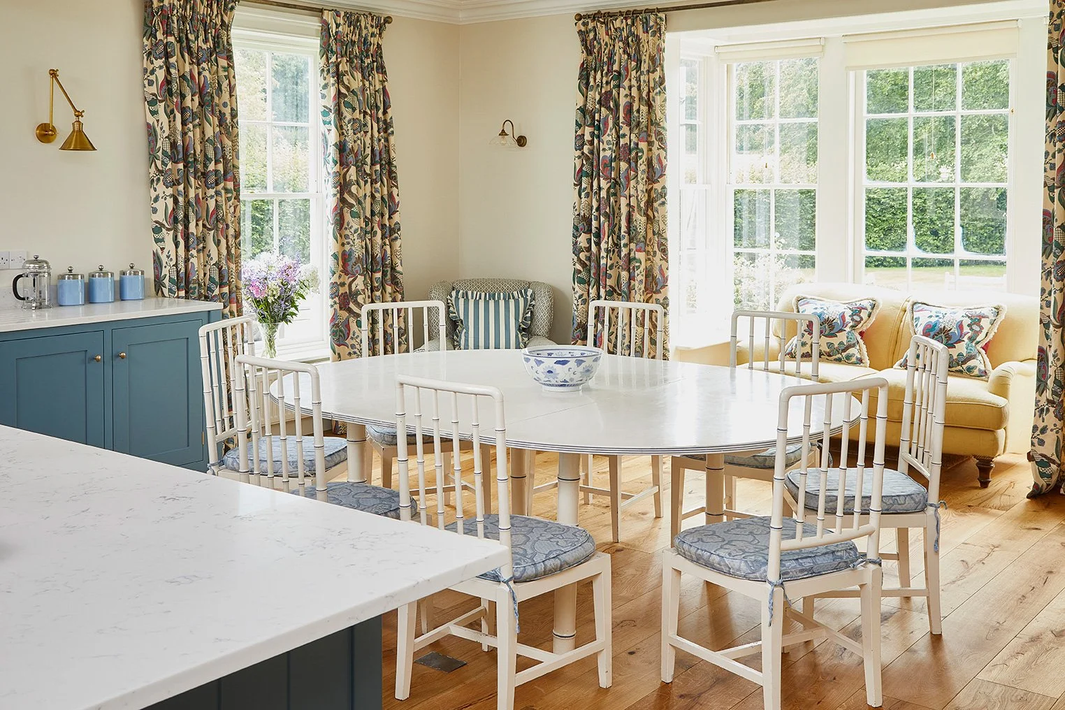 The bright kitchen diner at Meadow House with doors out to the garden