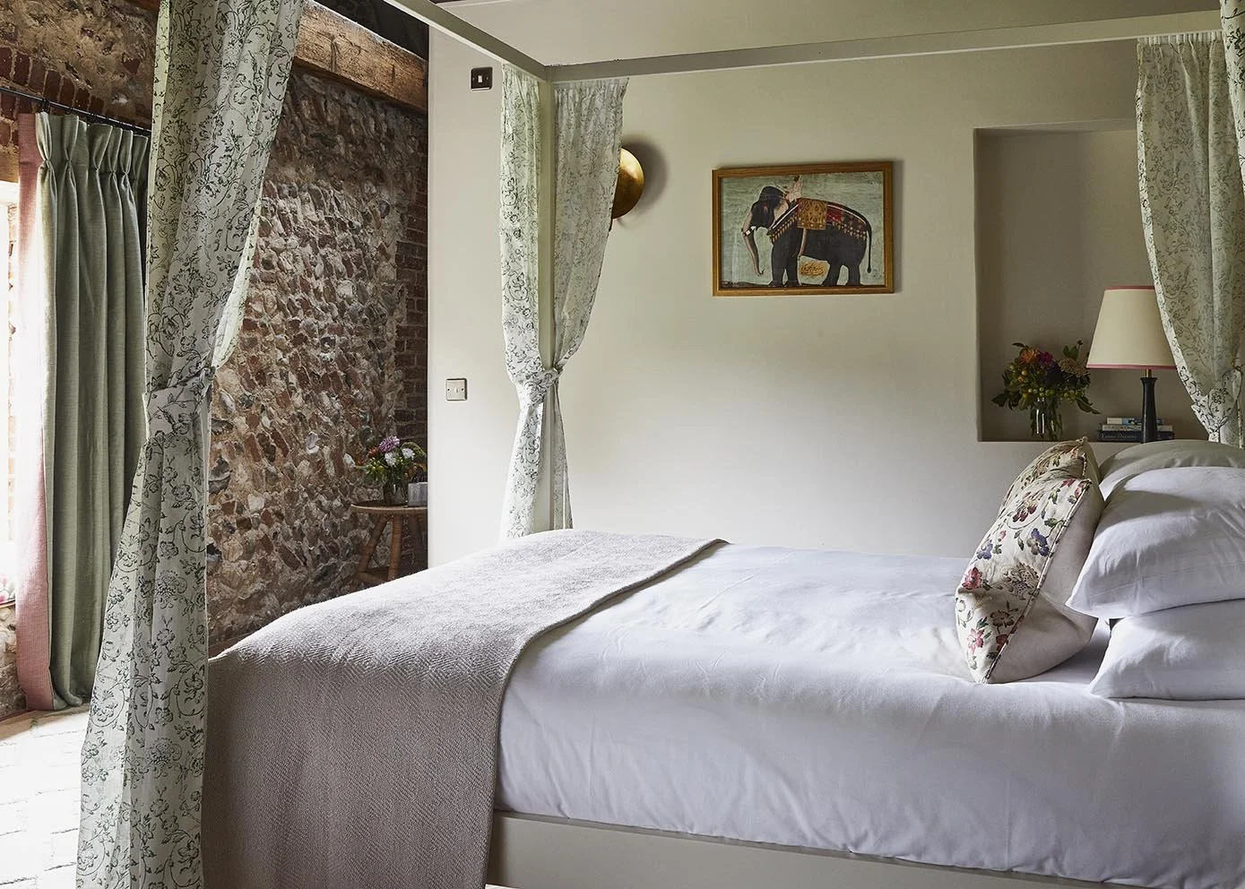 The light-filled master bedroom in High Barsham with four poster bed