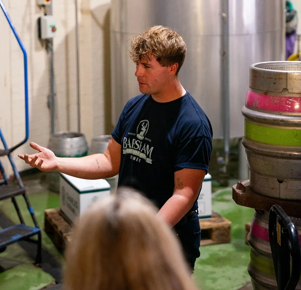 Hamish wearing a branded logo t shirt on a brewery tour at Barsham Brewery