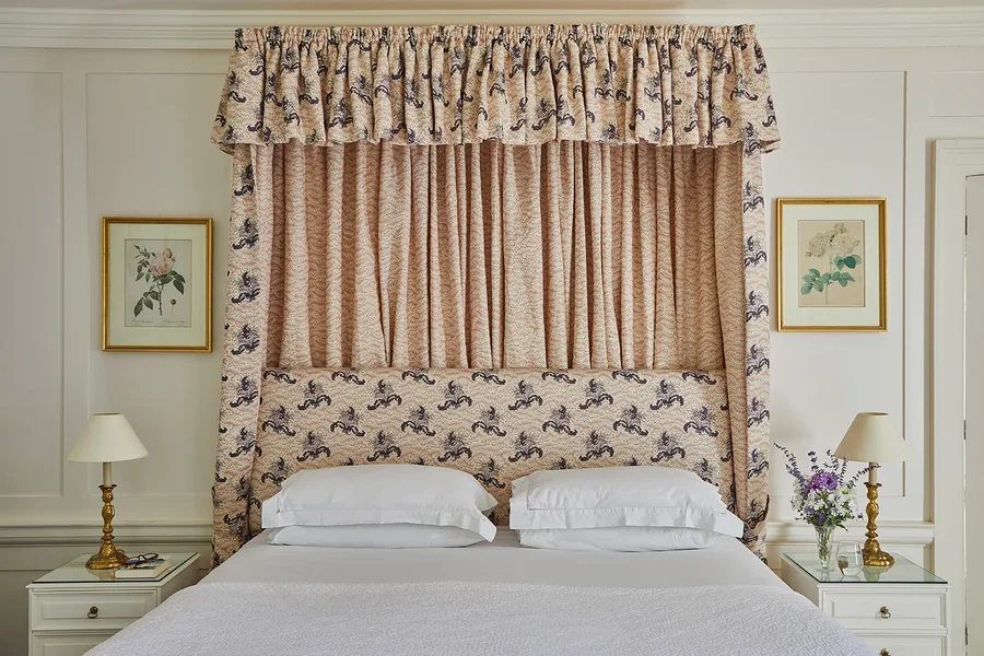 A tester bed in one of the light-filled bedrooms in Meadow House