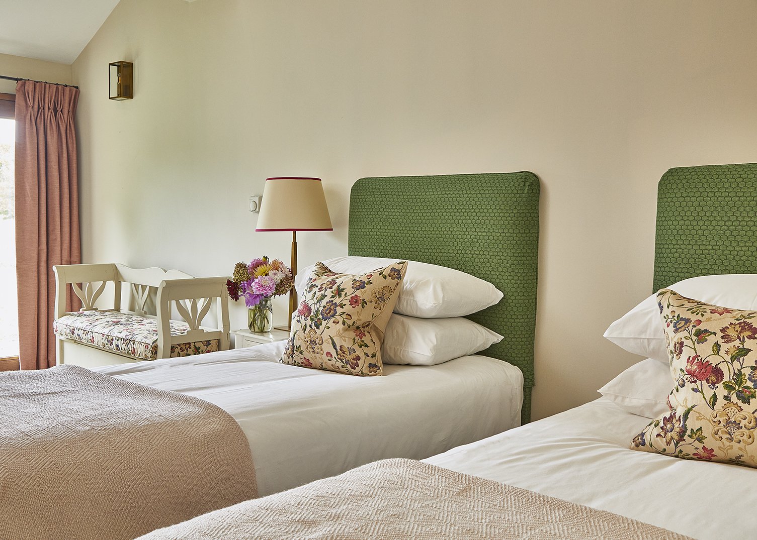 A light and airy twin bedroom with a door out to the garden
