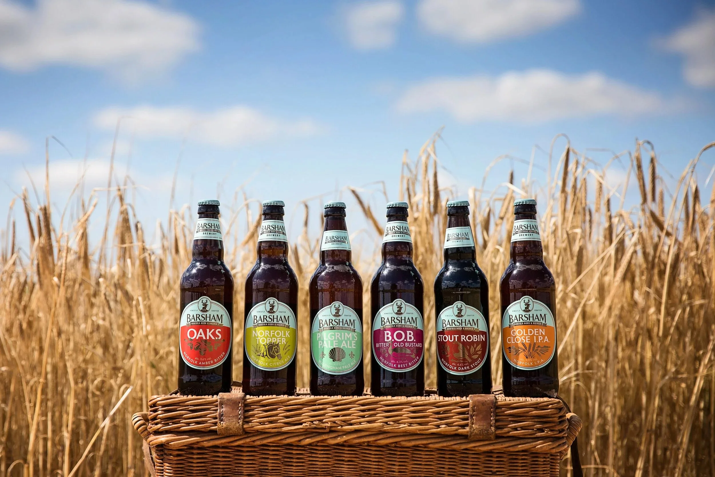 Beer from Barsham Brewery's collection in one of the fields where the malting barley is grown