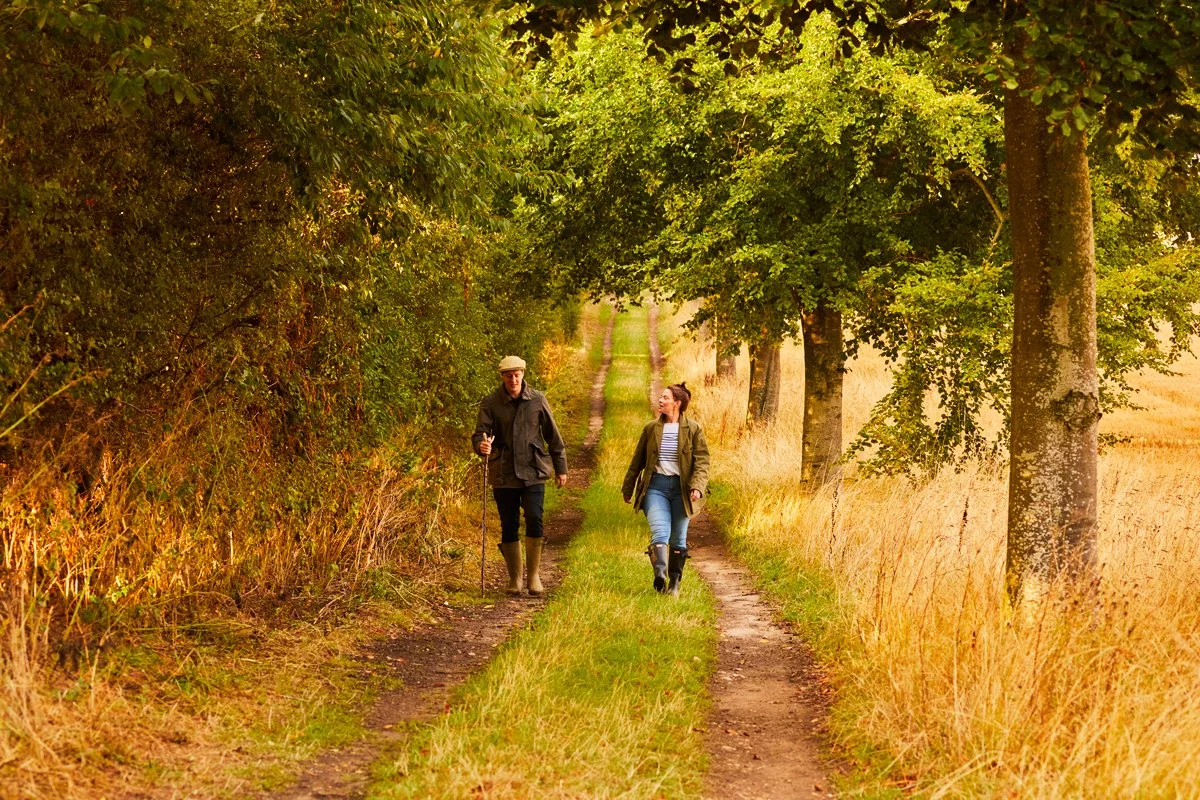A couple walking the extensive footpaths through the countryside on and around the estate