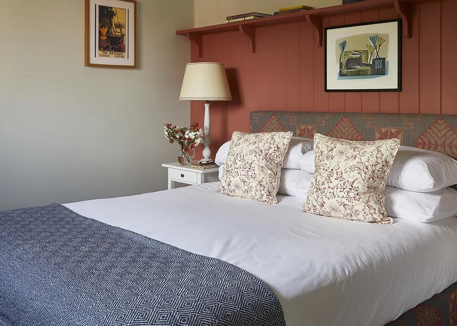 The cosy double bedroom in The Loose Box with tongue and groove cladding and cosy fabrics