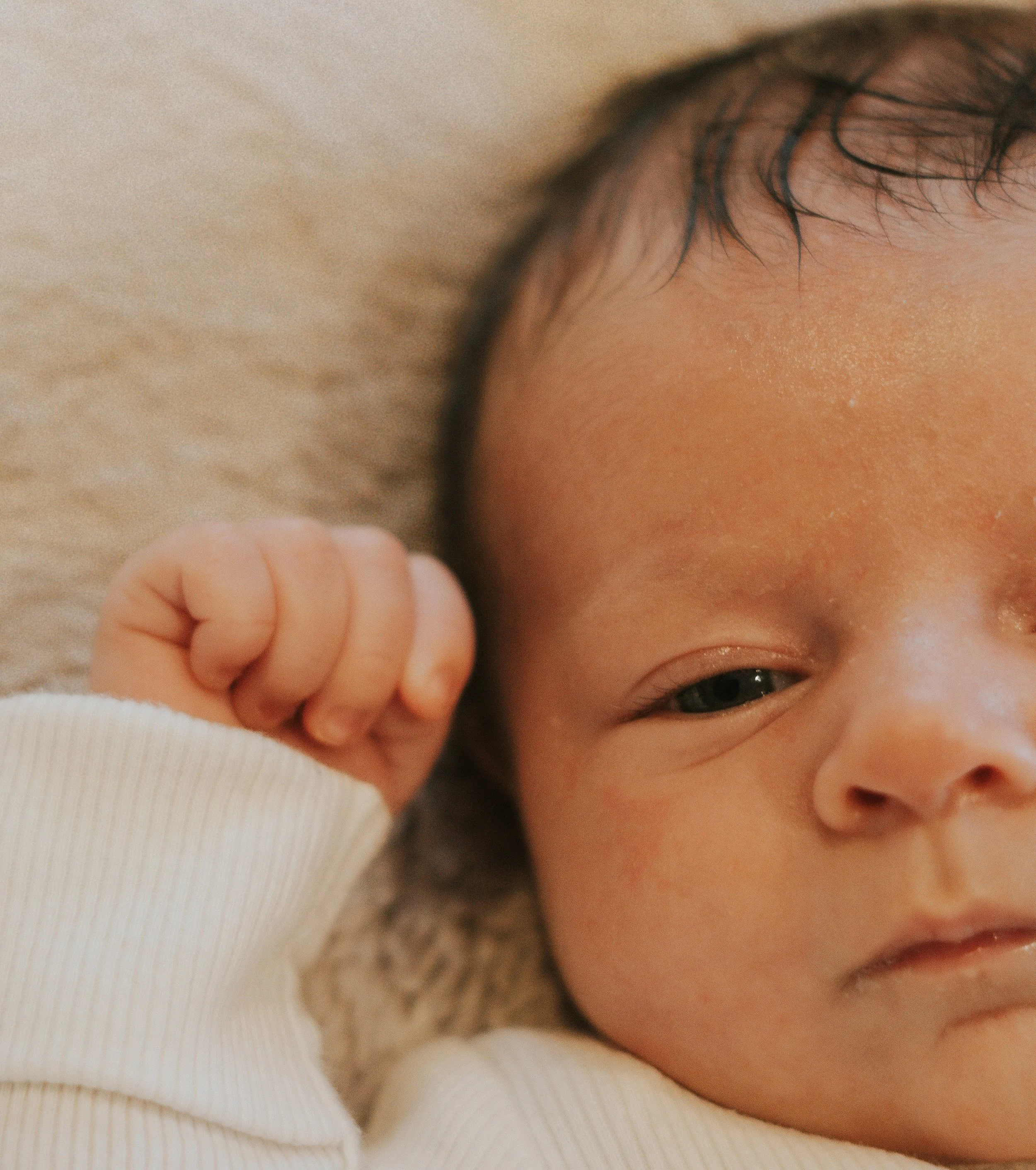 Natural in-home newborn photography session in Sussex by lifestyle photographer The Sussex Storyteller.