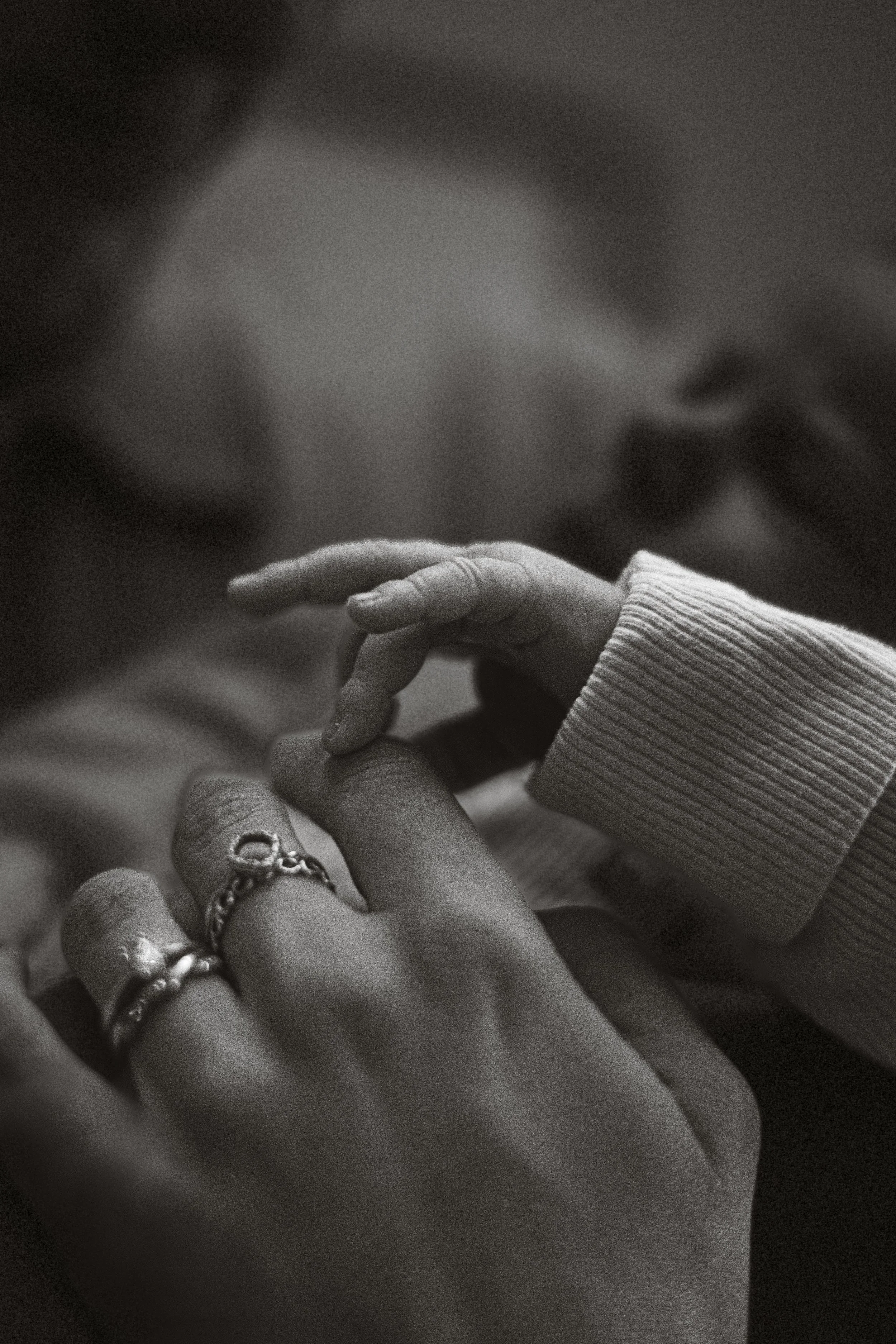 Intimate, close up black and white photography capturing tiny details and family connection.