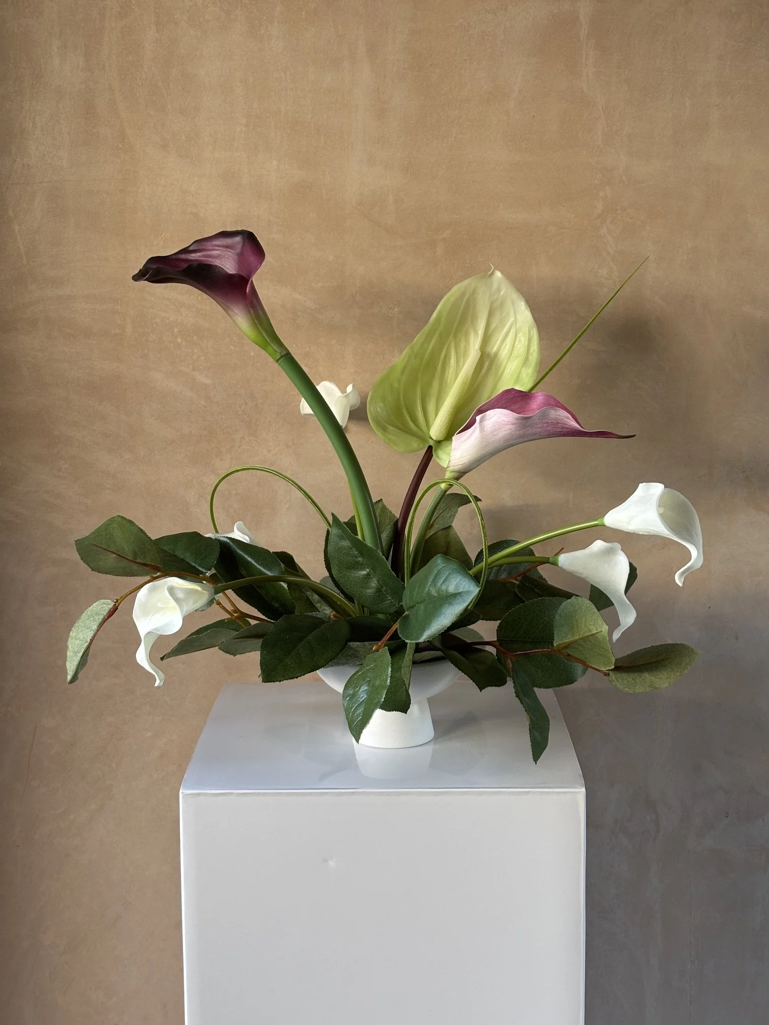 Totally bespoke table displays with Salal leaves and Cala Lilies.