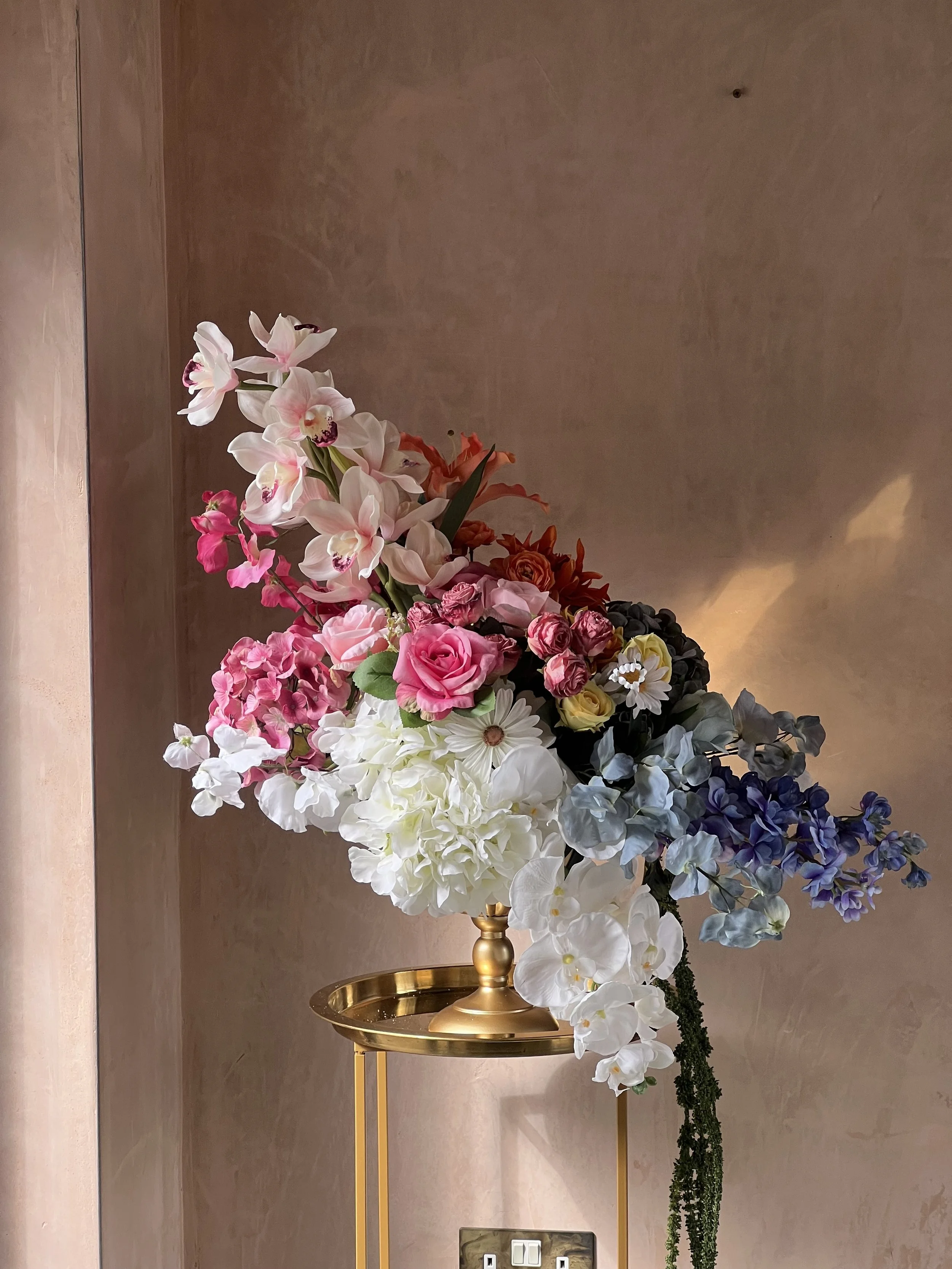 Totally bespoke burst of colour medium urn with orchids
