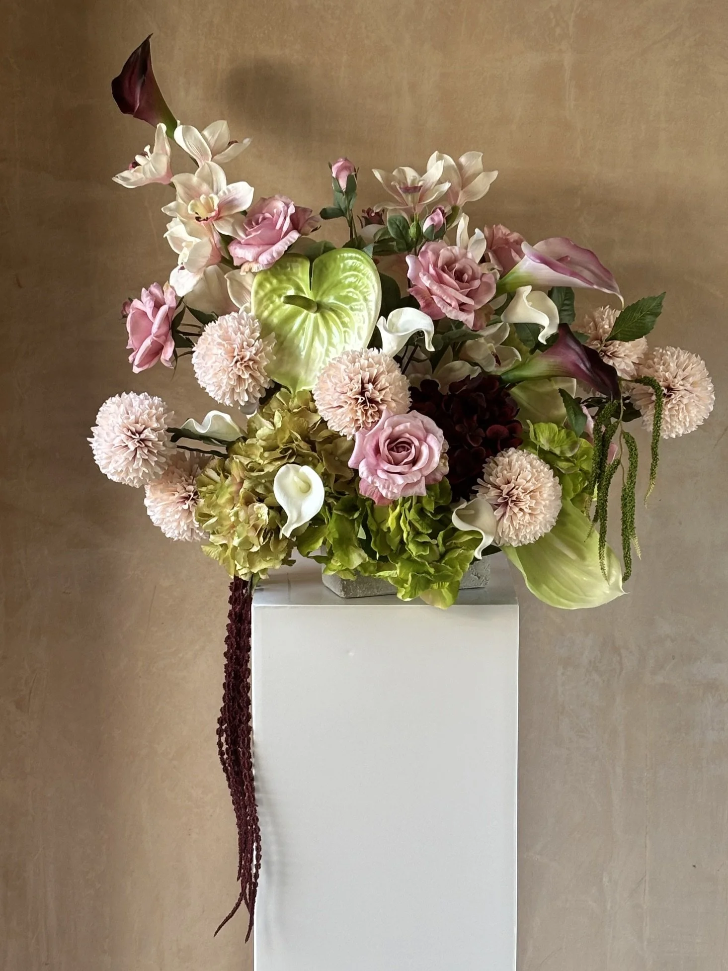 Bespoke large display on pillar modern architectural style with Cala Lilies and Anthuriums.