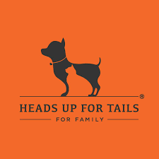 Logo featuring a black silhouette of a dog wearing a collar on an orange background with text 'Heads Up for Tails for Family'.