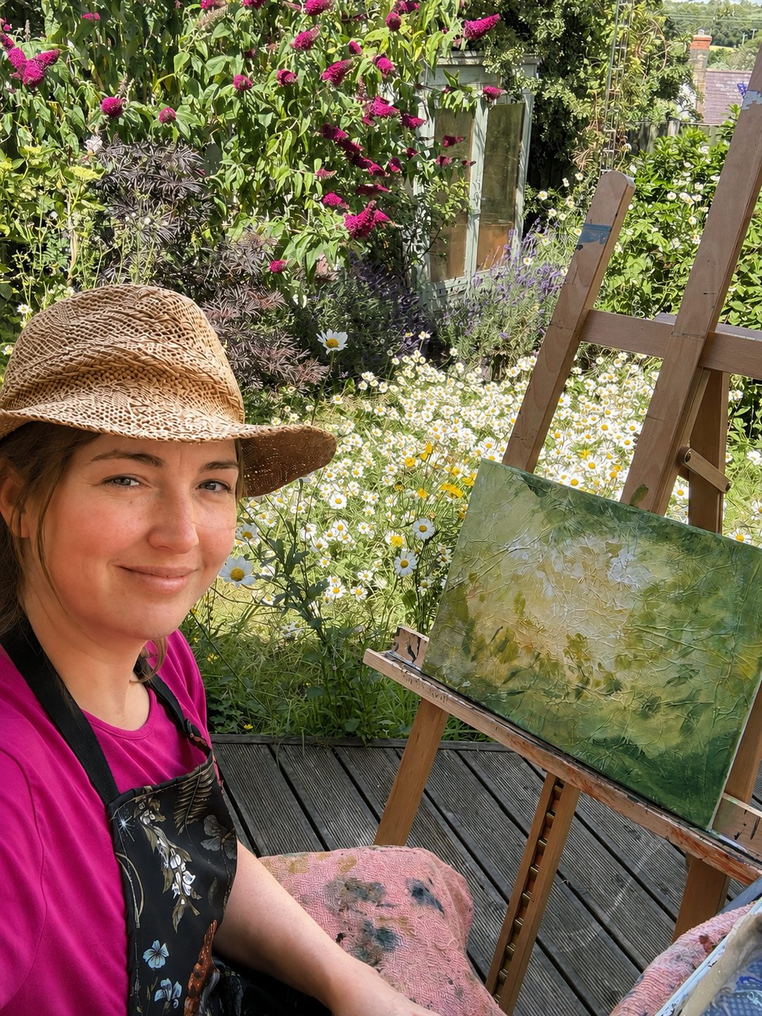 Artist Tracey Anne Green painting outdoors in her studio garden.