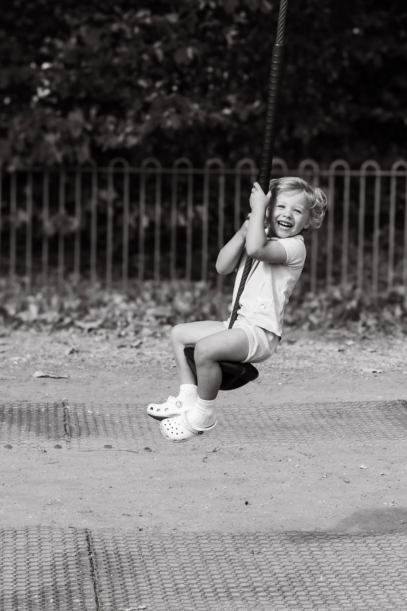 Boy laughing while having fun at the playground.