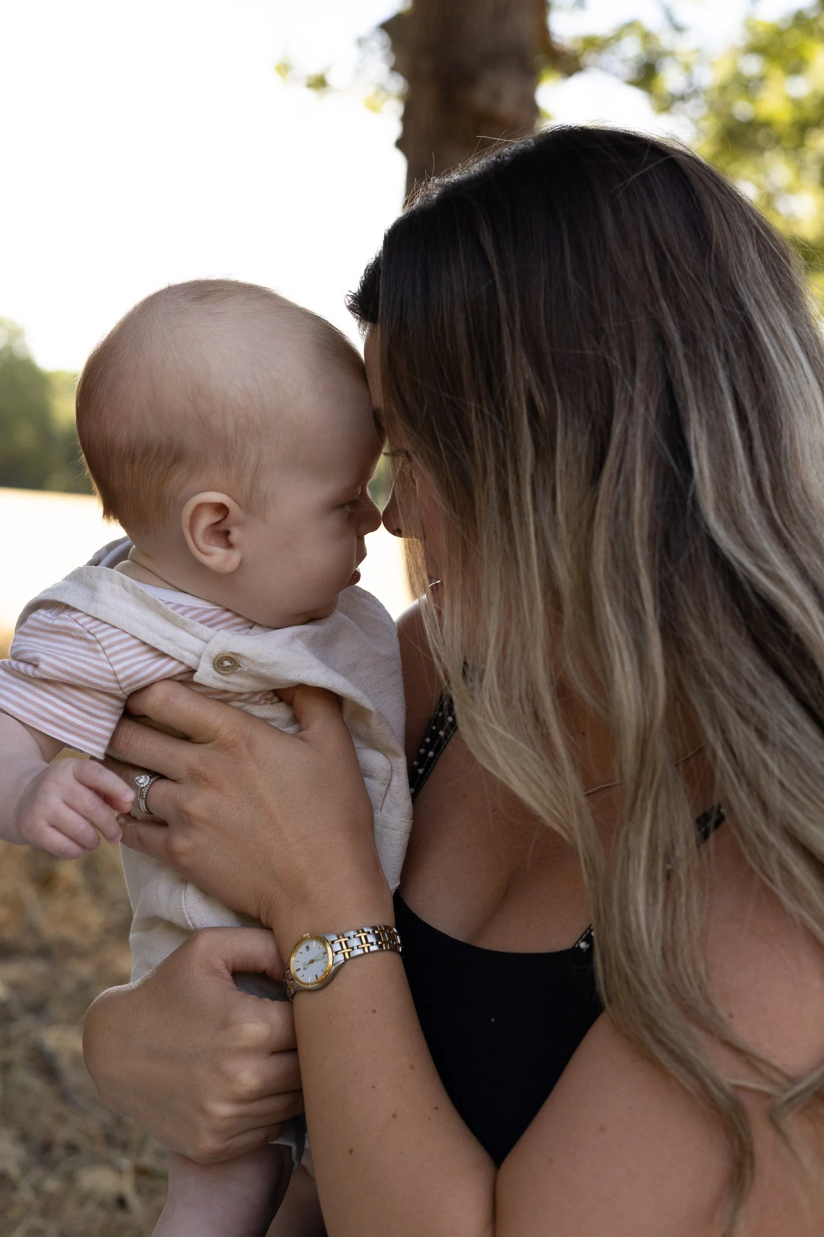 Mother having a close moment with her baby while being photographed in Farnborough.