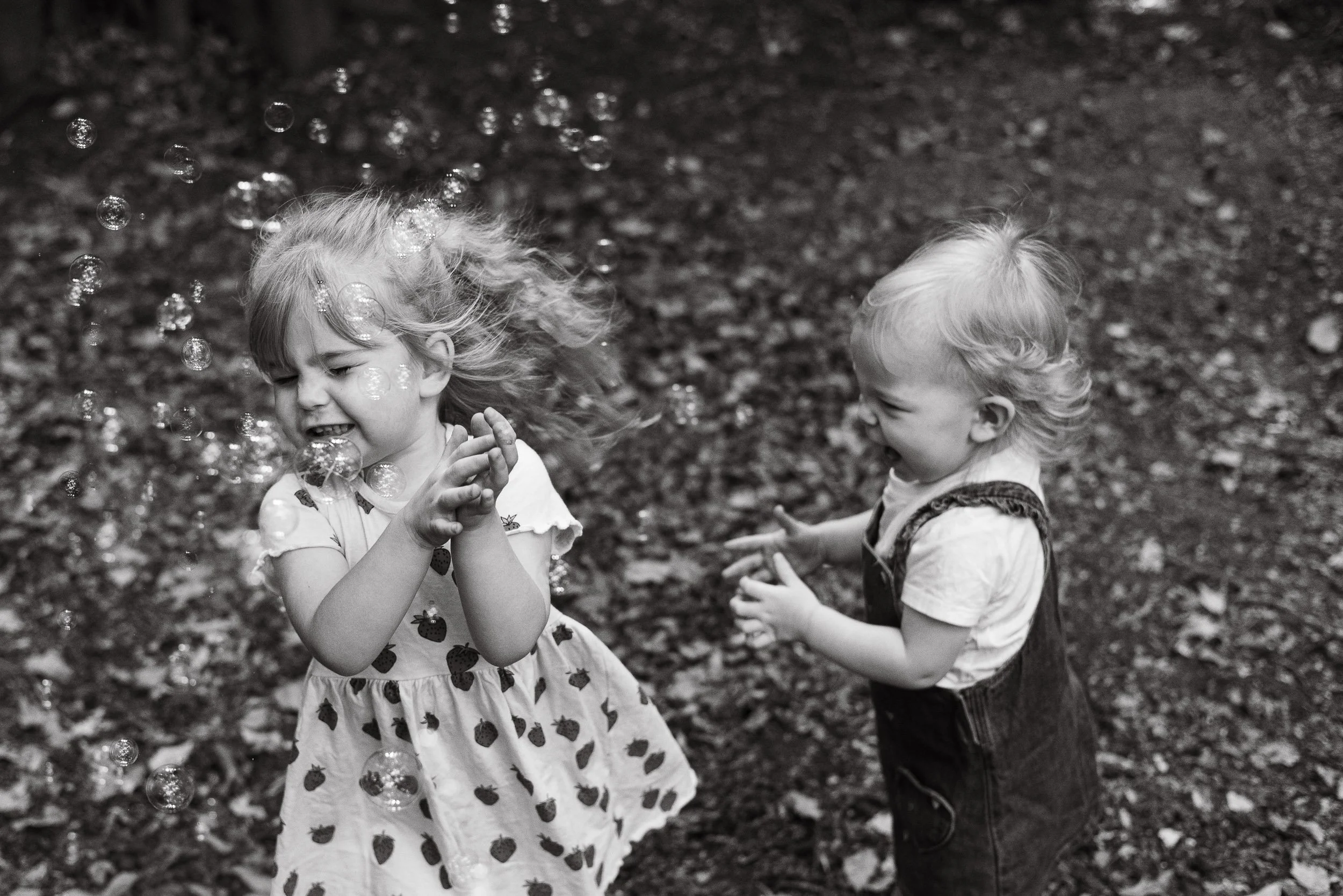 Documentary style picture of children playing with bubbles.