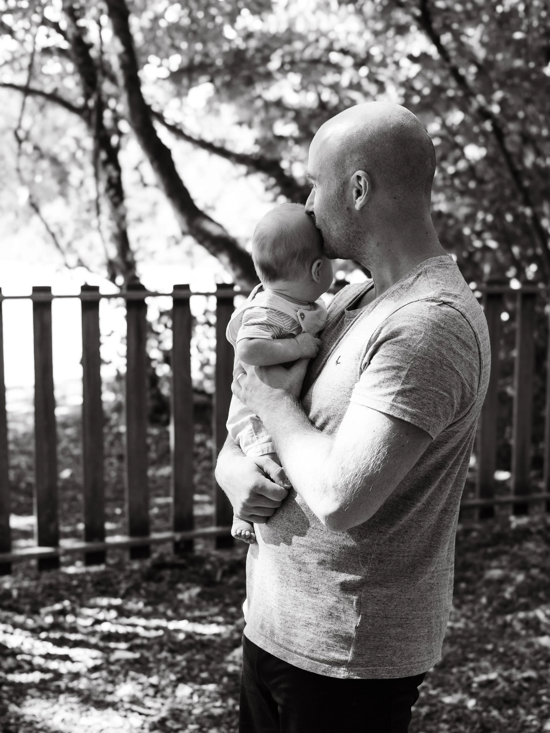 Father having a candid moment with his baby during documentary style photography session in Blackwater.