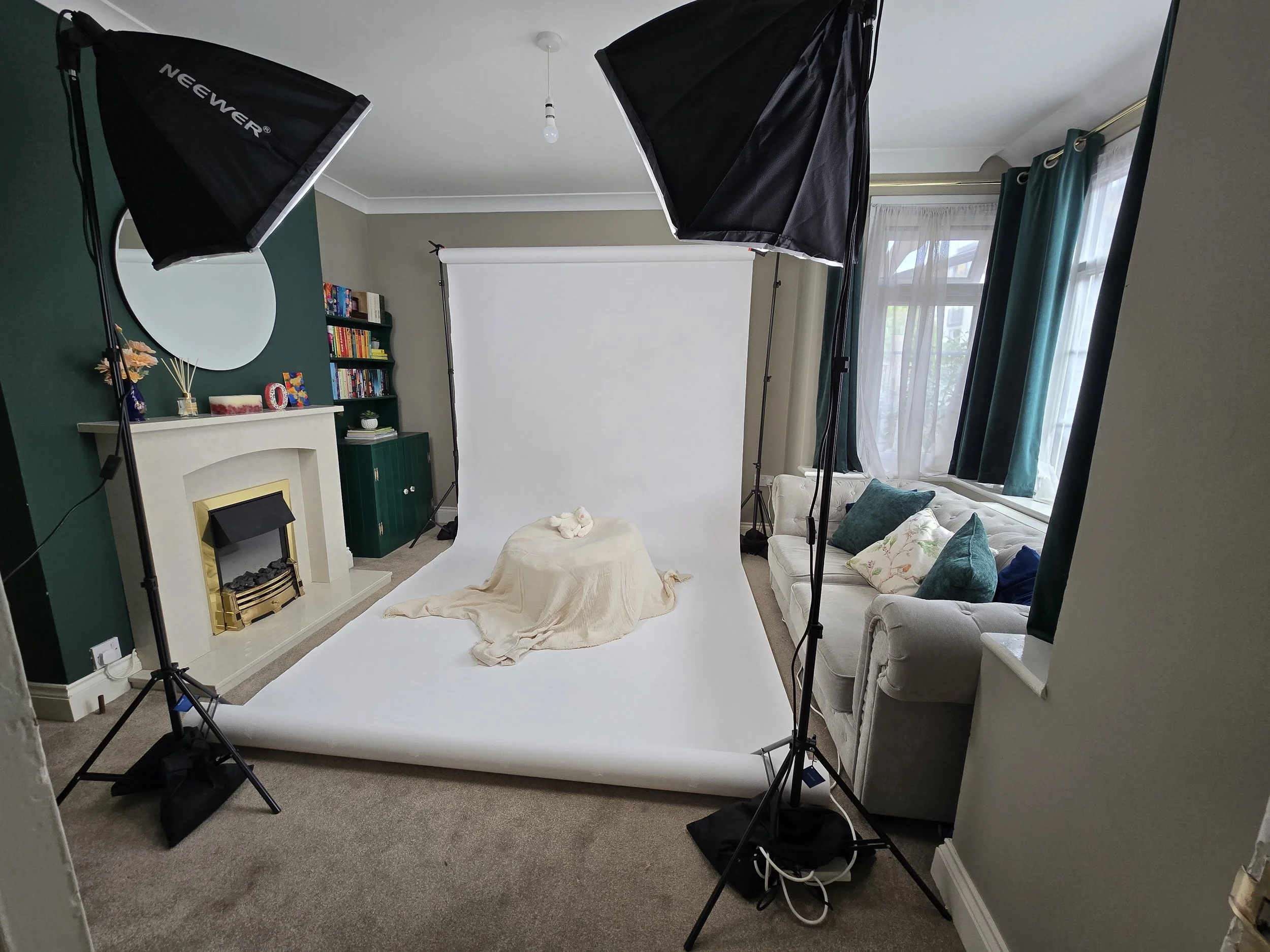 Compact portable photography studio backdrop set up in a living room.