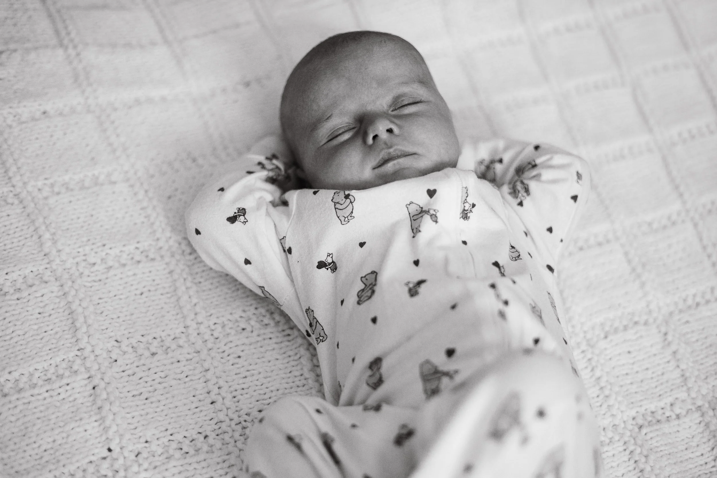 Newborn baby sleeping on the blanket during newborn photoshoot in Fleet.