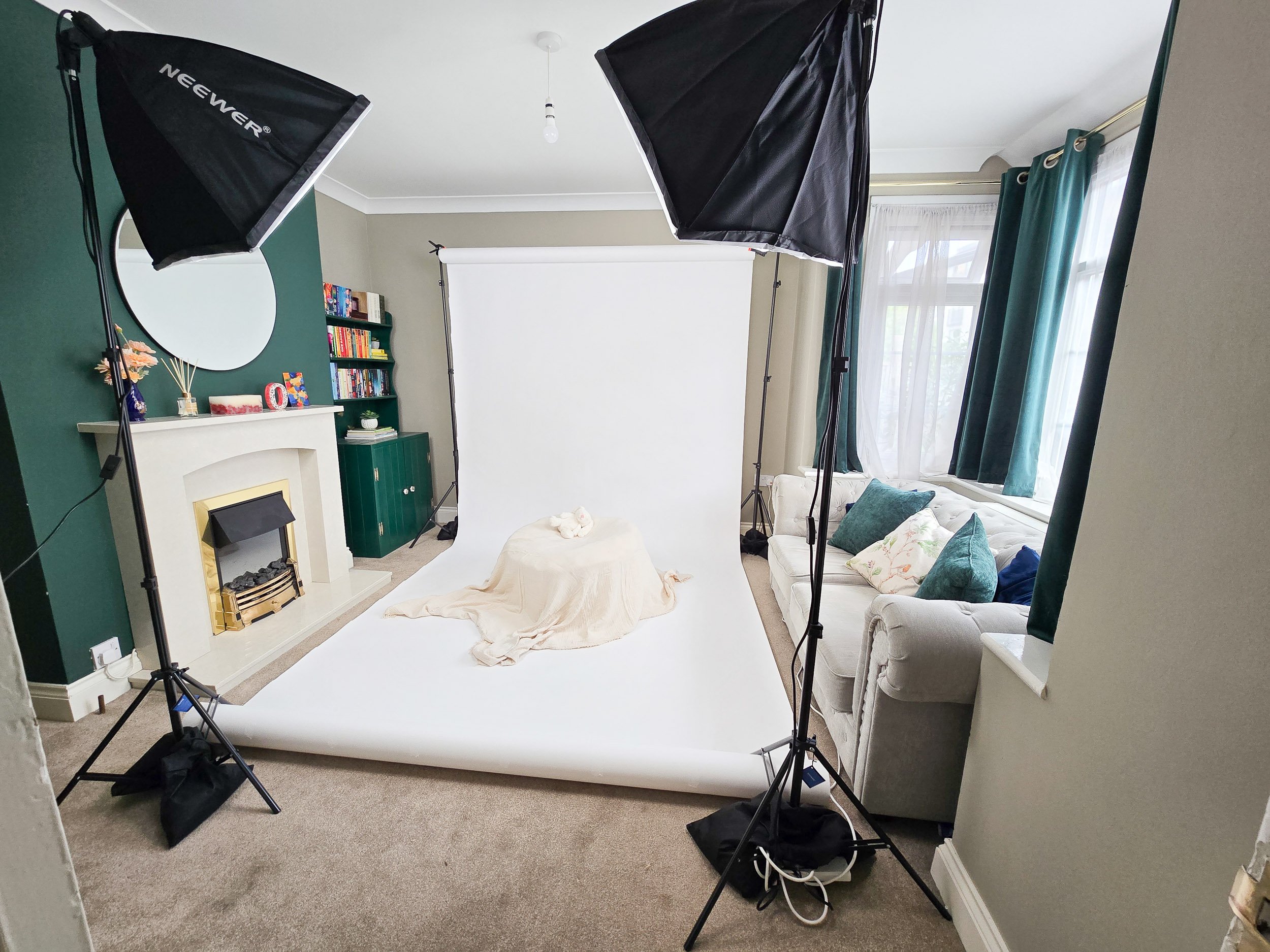 Professional portable photography studio backdrop and softbox lights set up inside client living room