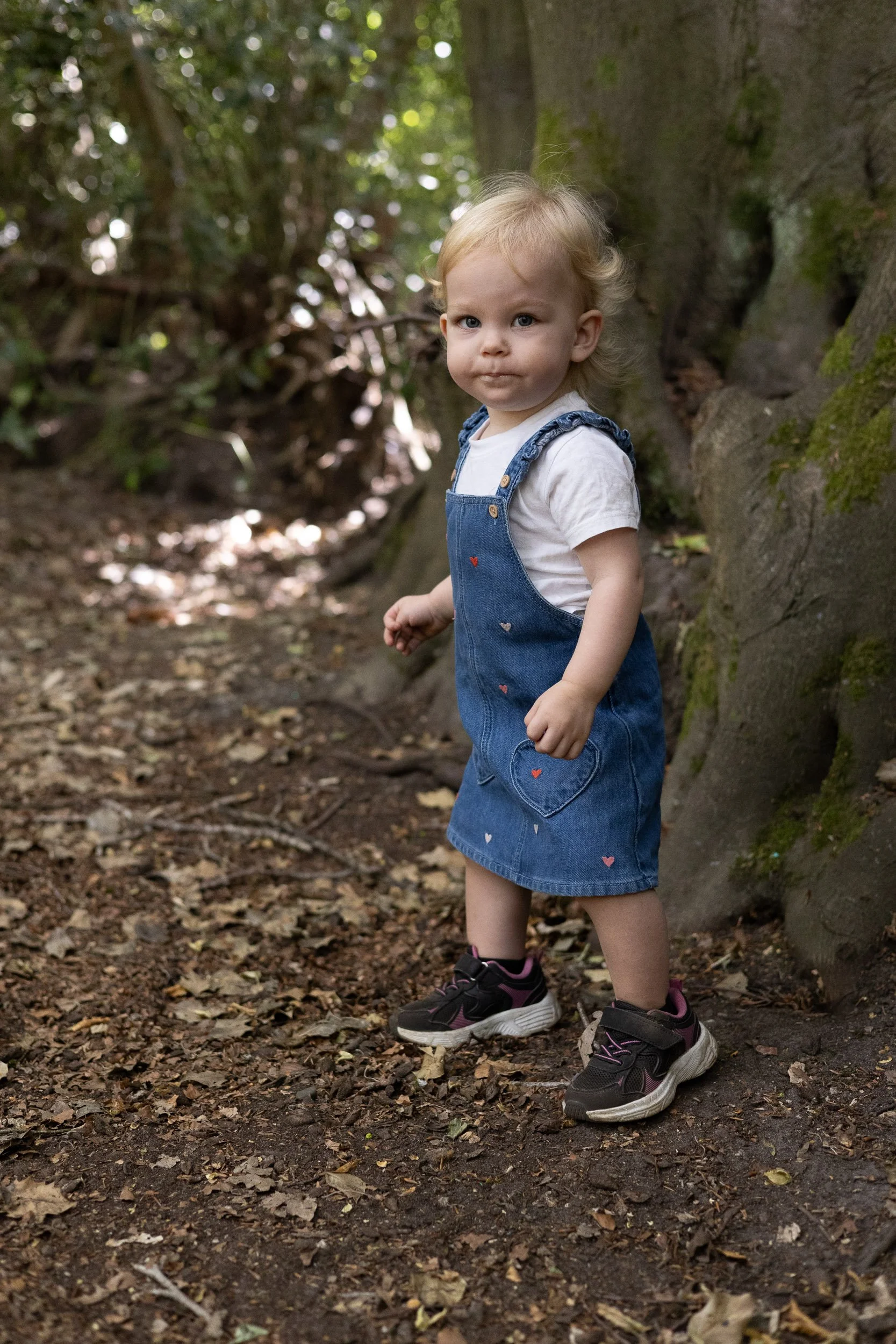 Toddler looking at the camera while having fun at Frimley Lodge Park,
