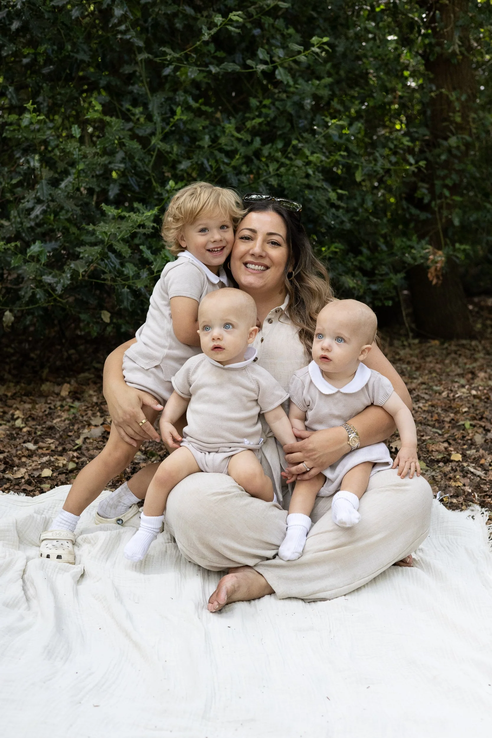 Mother cuddling her children during an outdoor photoshoot in Camberley.