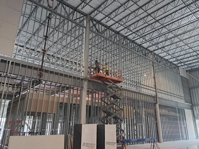 Two story interior framing on scissor lift.
