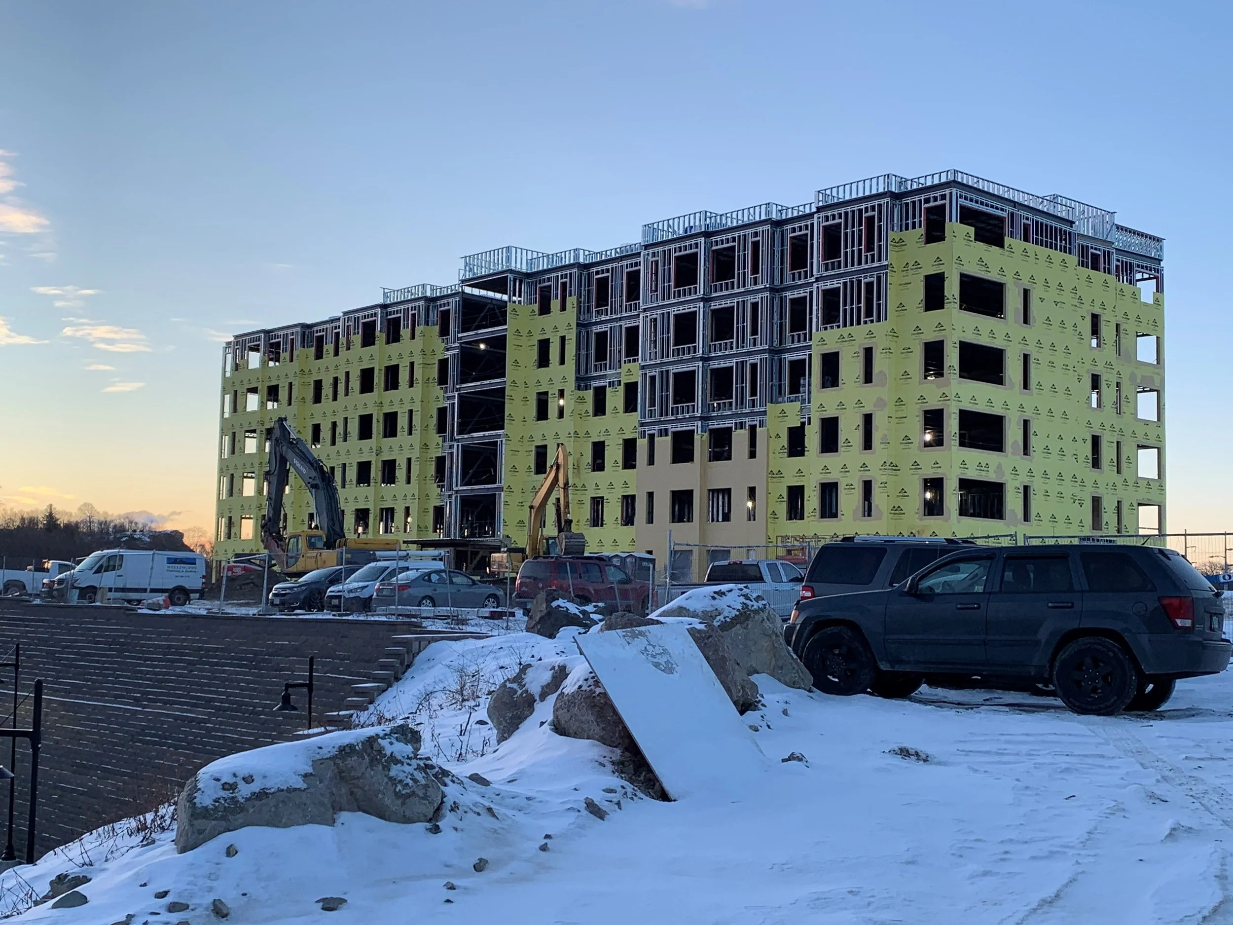 Ground up building with Dens glass sheathing being installed.