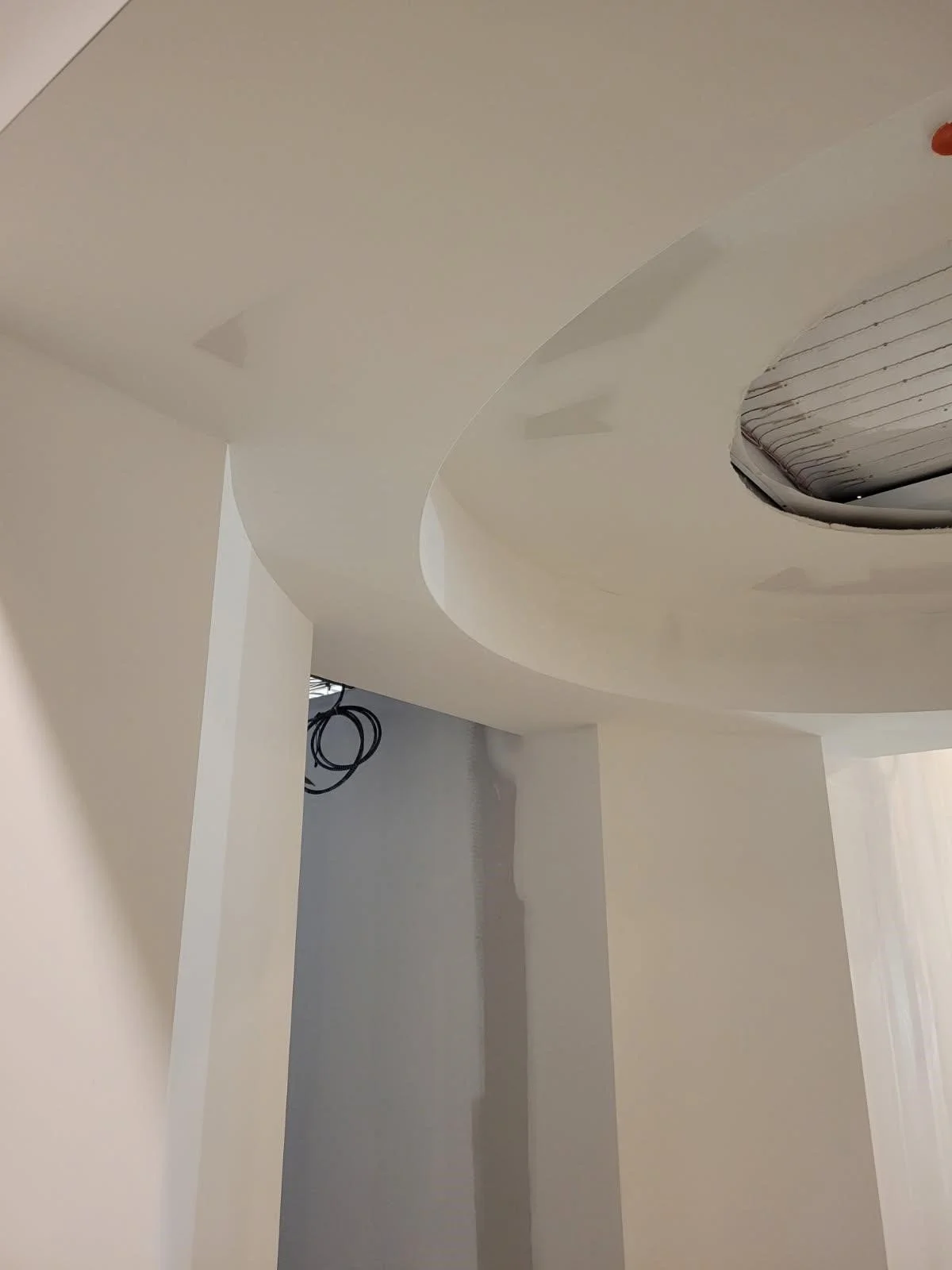 Radius drywall ceiling taped and sanded to a level 4 finish ready for paint.