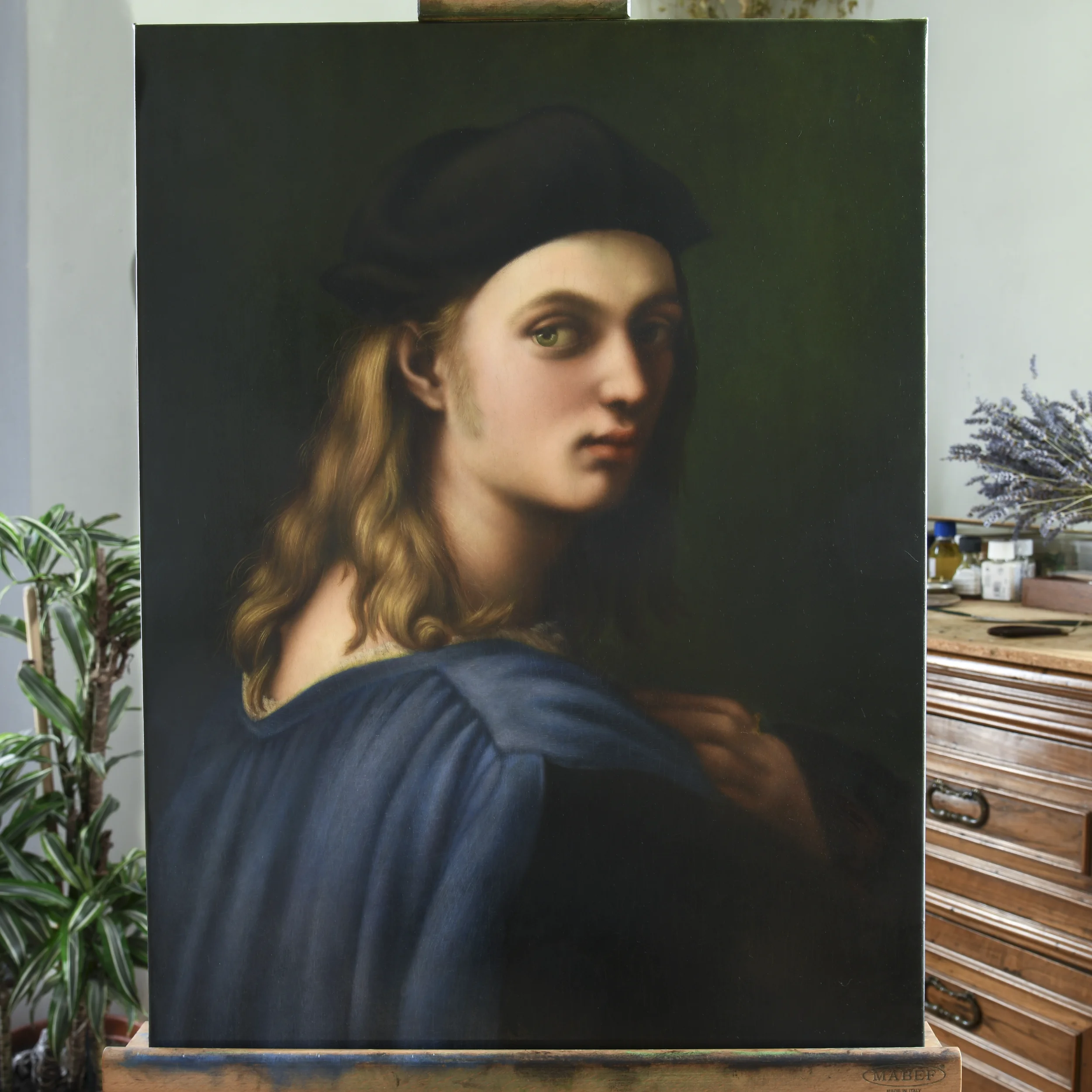 An oil painting copy of Portrait of Bindo Altoviti after Raphael by Anna Sumislawska, displayed on an easel in a studio, with the artist’s workspace visible in the background.