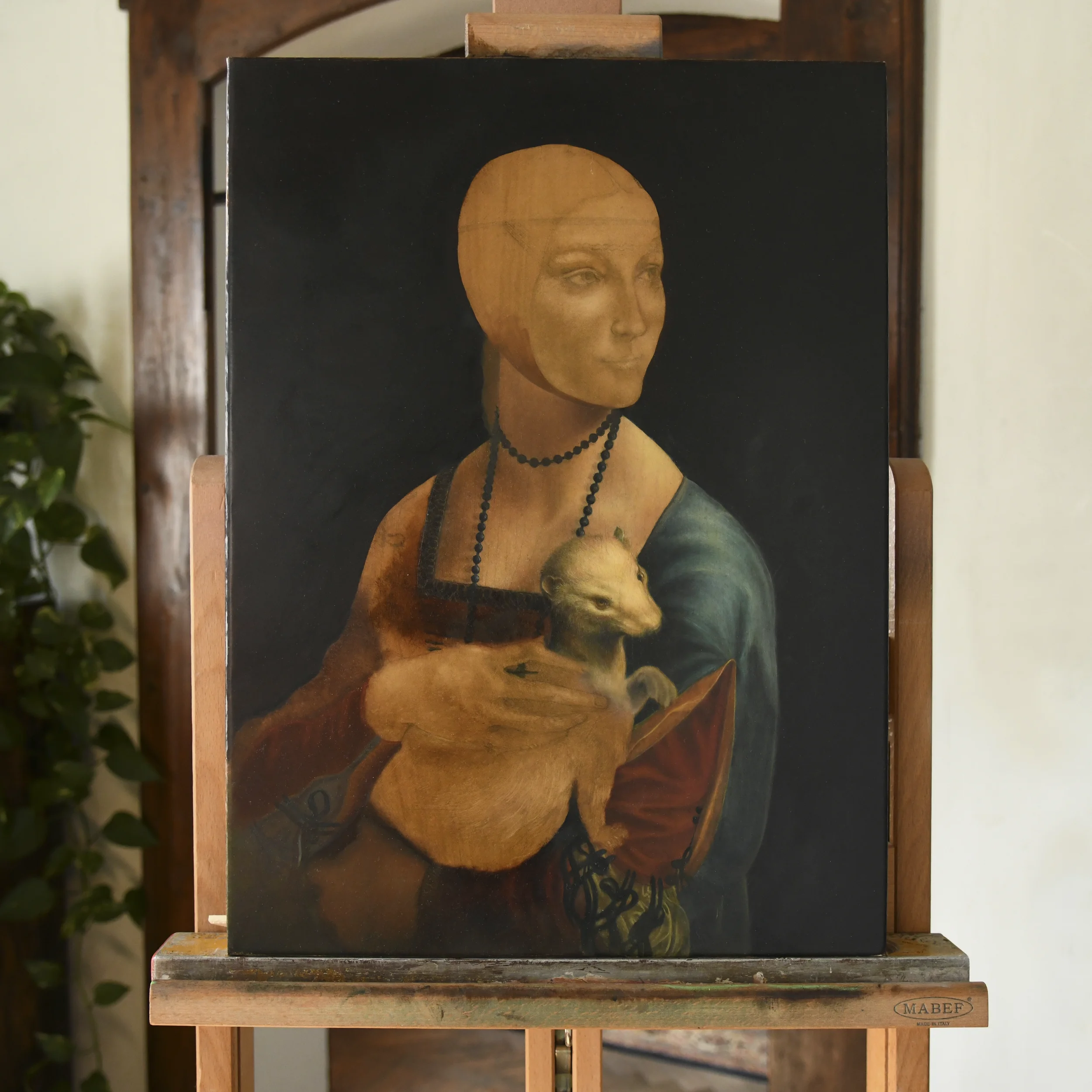 Work in progress oil painting copy of Lady with an Ermine after Leonardo da Vinci by Anna Sumislawska, displayed on a wooden easel. The portrait is still unfinished, with the face not yet completed. 