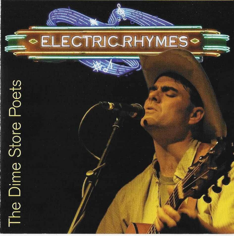 Album cover for Electric Rhymes featuring a male singer wearing a cowboy hat, singing into a microphone, and playing an acoustic guitar. Neon sign with the words "Electric Rhymes" and additional neon music notes and symbols