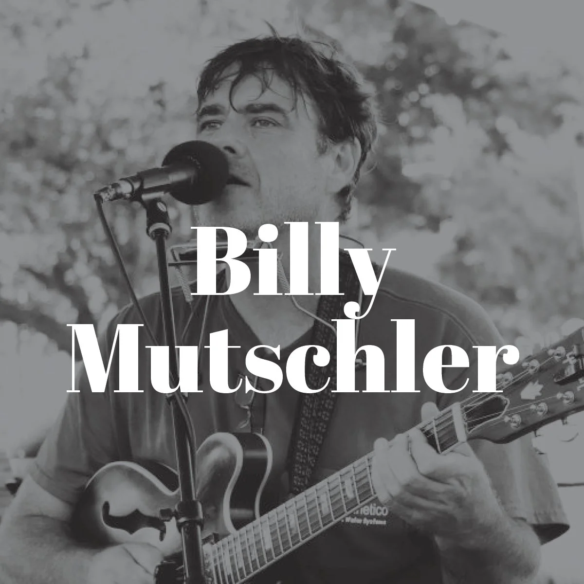 Black and white photo of a man singing into a microphone while playing an acoustic guitar outdoors, with trees in the background. Overlaid text reads 'Billy Mutschler'.