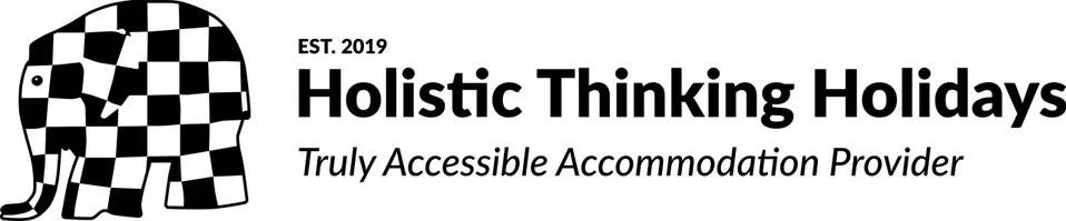 Logo of Holistic Thinking Holidays, a black and white checkered elephant, with text 'EST. 2019 Holistic Thinking Holidays Truly Accessible Accommodation Provider'.