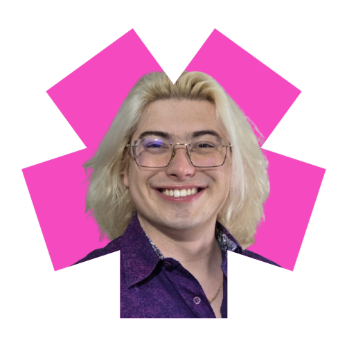 A person with medium length blond hair, glasses, and a purple shirt, smiling.