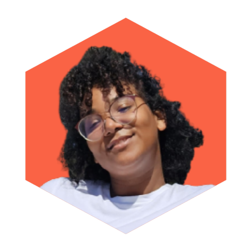 A smiling woman with curly hair and glasses.