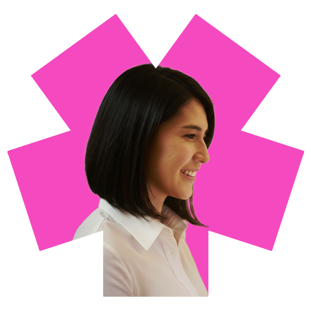 A smiling woman with shoulder-length dark hair wearing a white shirt.