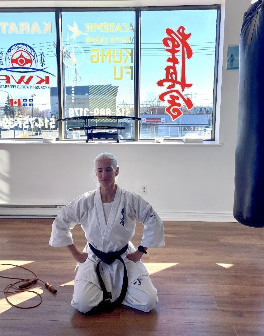 Silver hair mature Montreal Model in a dojo wearing her black belt
