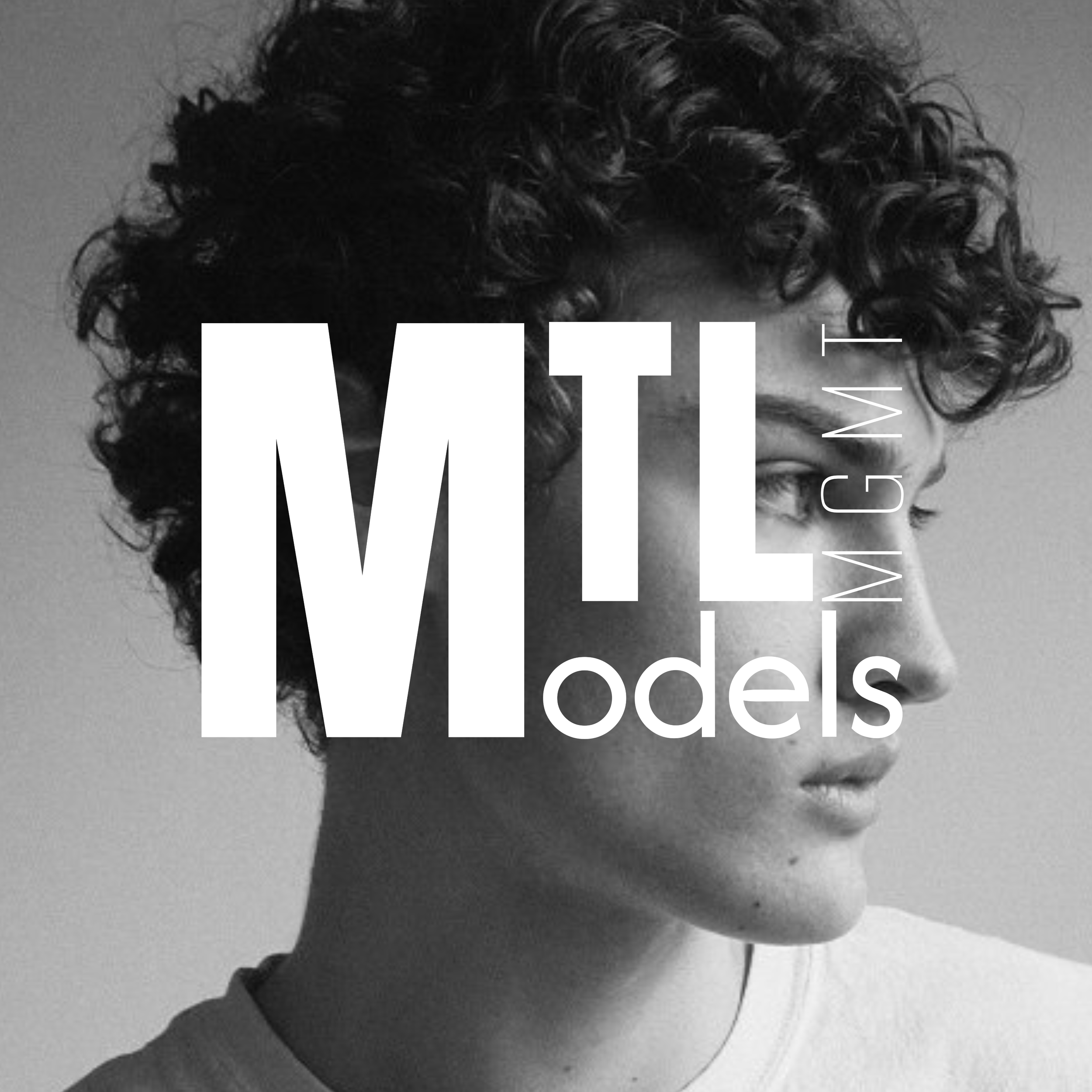 Black and white male model headshot featuring a clean, centered composition with the MTL Models MGMT logo overlaid on the image, presented in a professional branding style suitable for agency portfolio and promotional use.