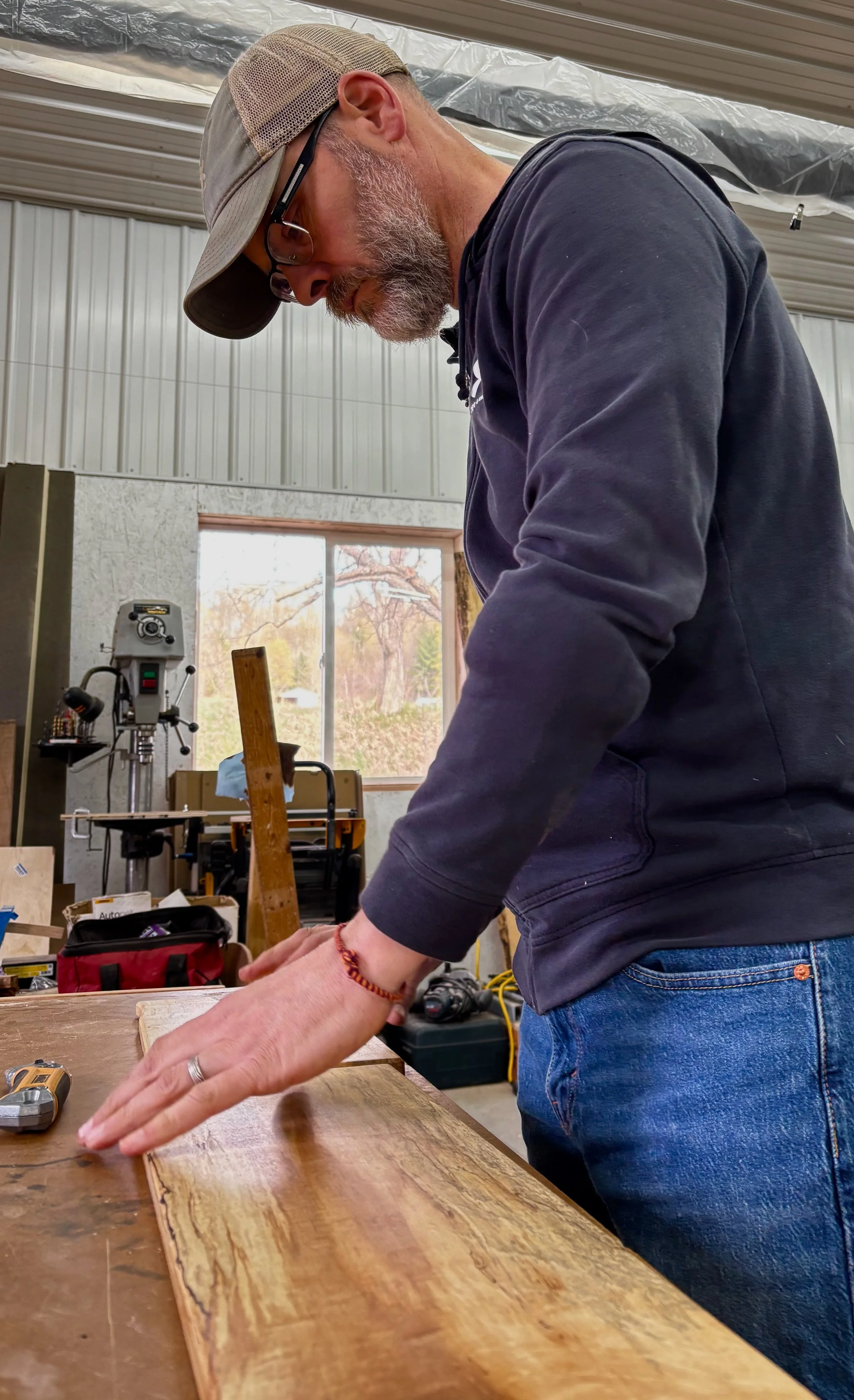 Tim working at his bench with the shop in the background