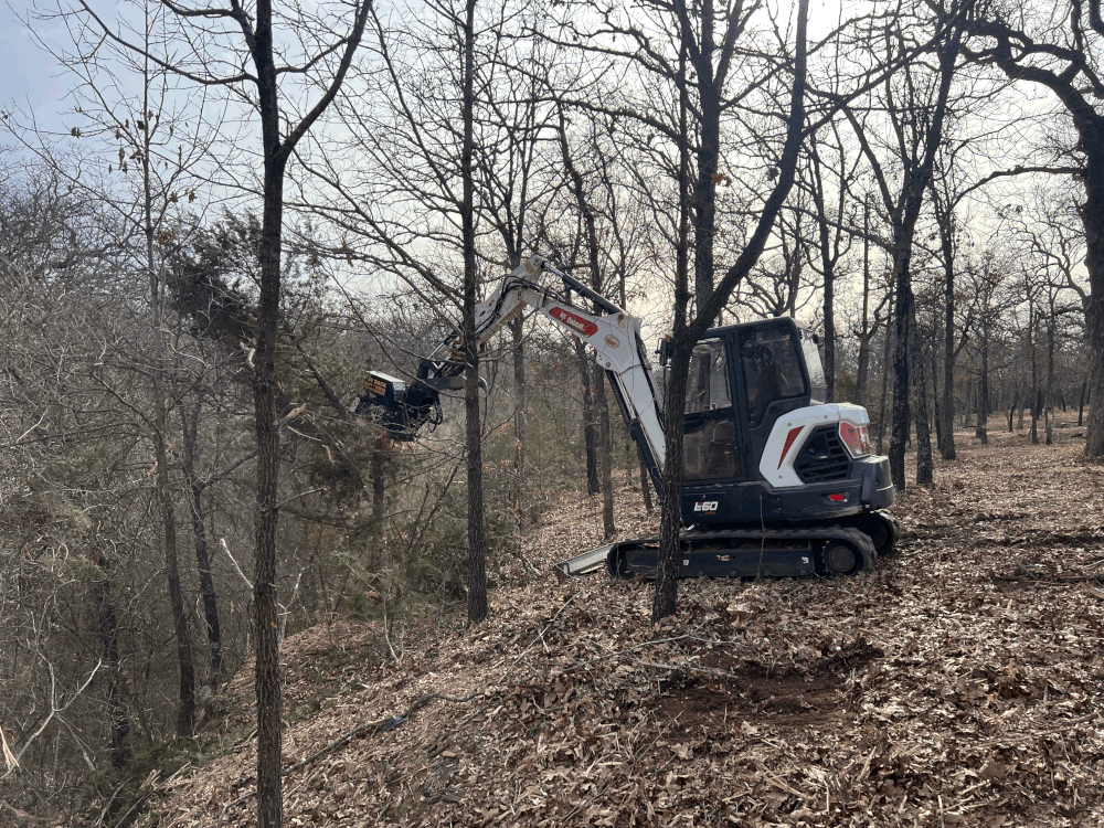 Excavator forestry mulcher clearing rough terrain in Oklahoma