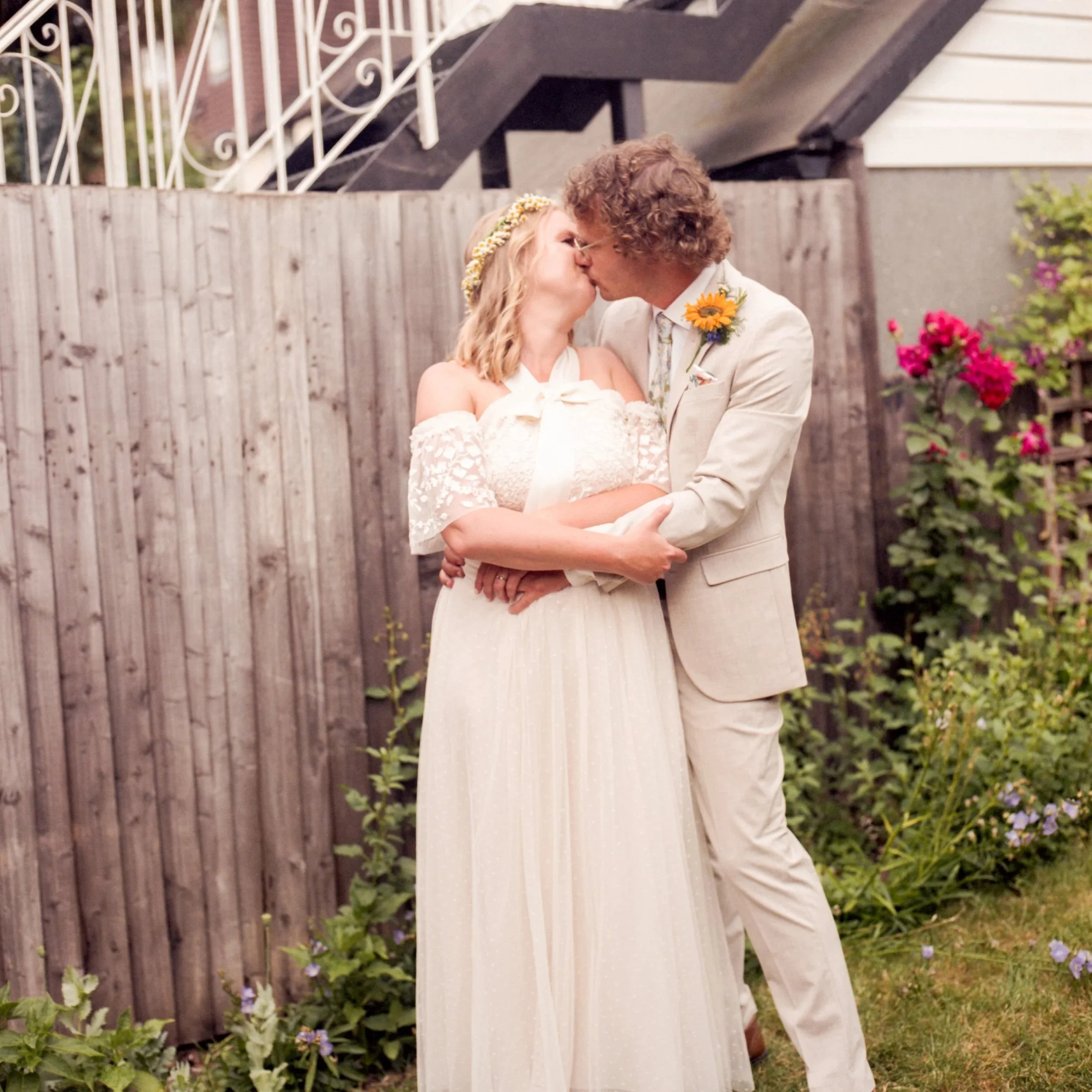 Bride and groom kissing in South London back garden