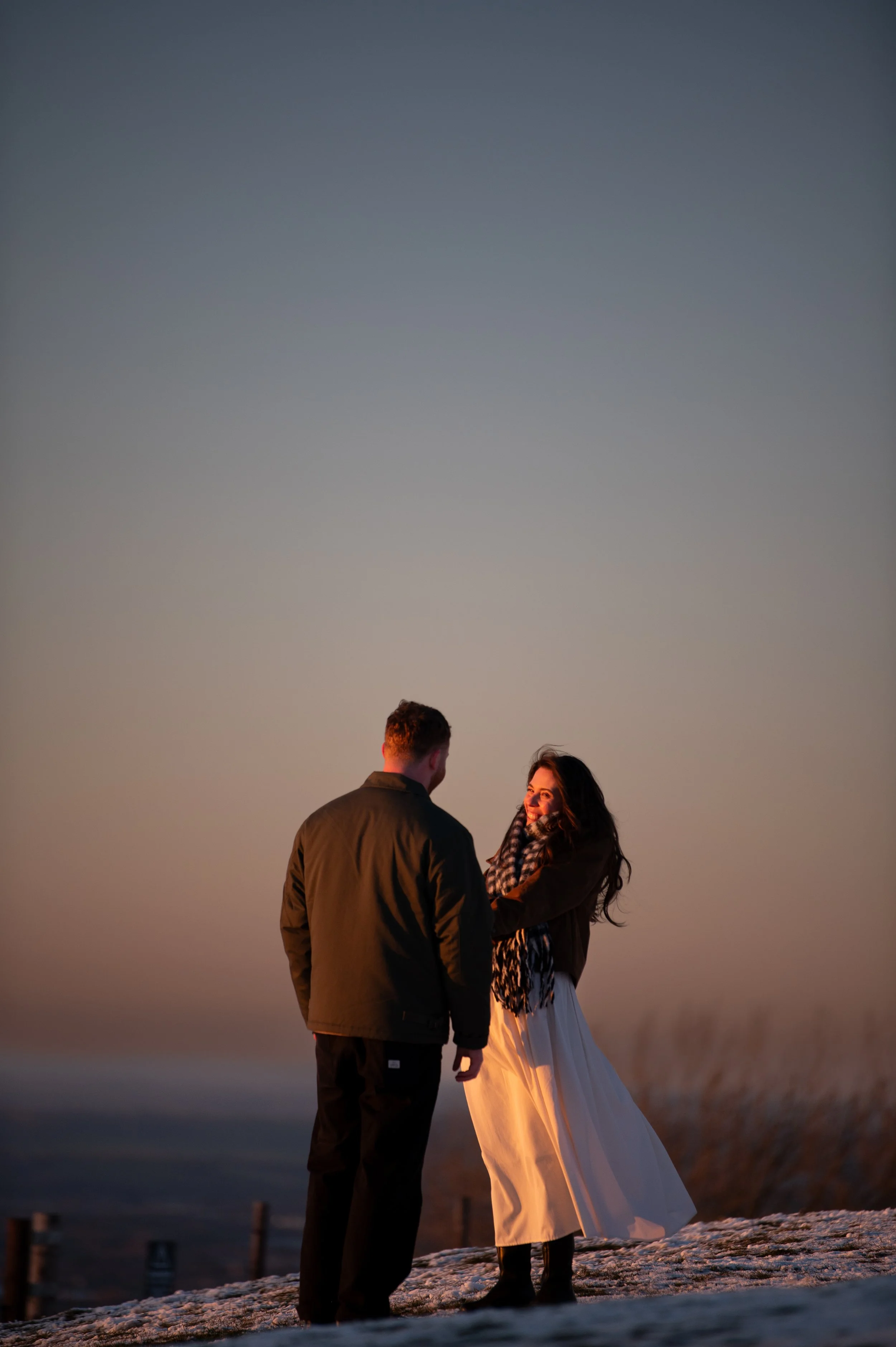 Laurie’s customers, Fernando and Kate embracing by the lake on their wedding day.