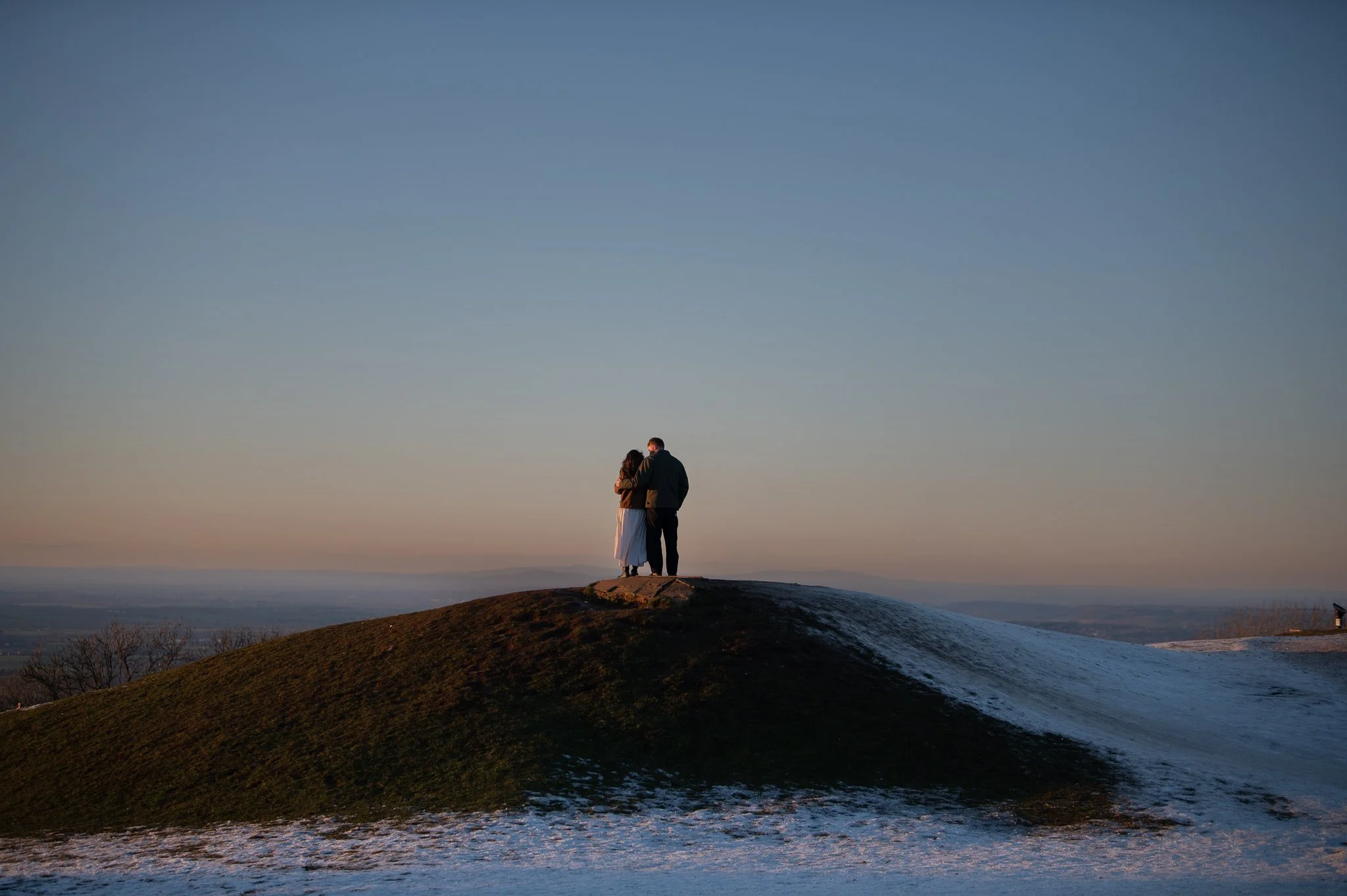 Engaged couple at sunset in winter in the Cotswolrds