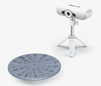 3D scanner with turntable and letters for capturing objects on a white background.