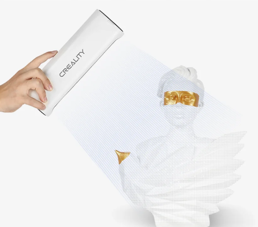 A hand holding a Creality 3D scanner, scanning a golden and white 3D bust with a digital overlay.
