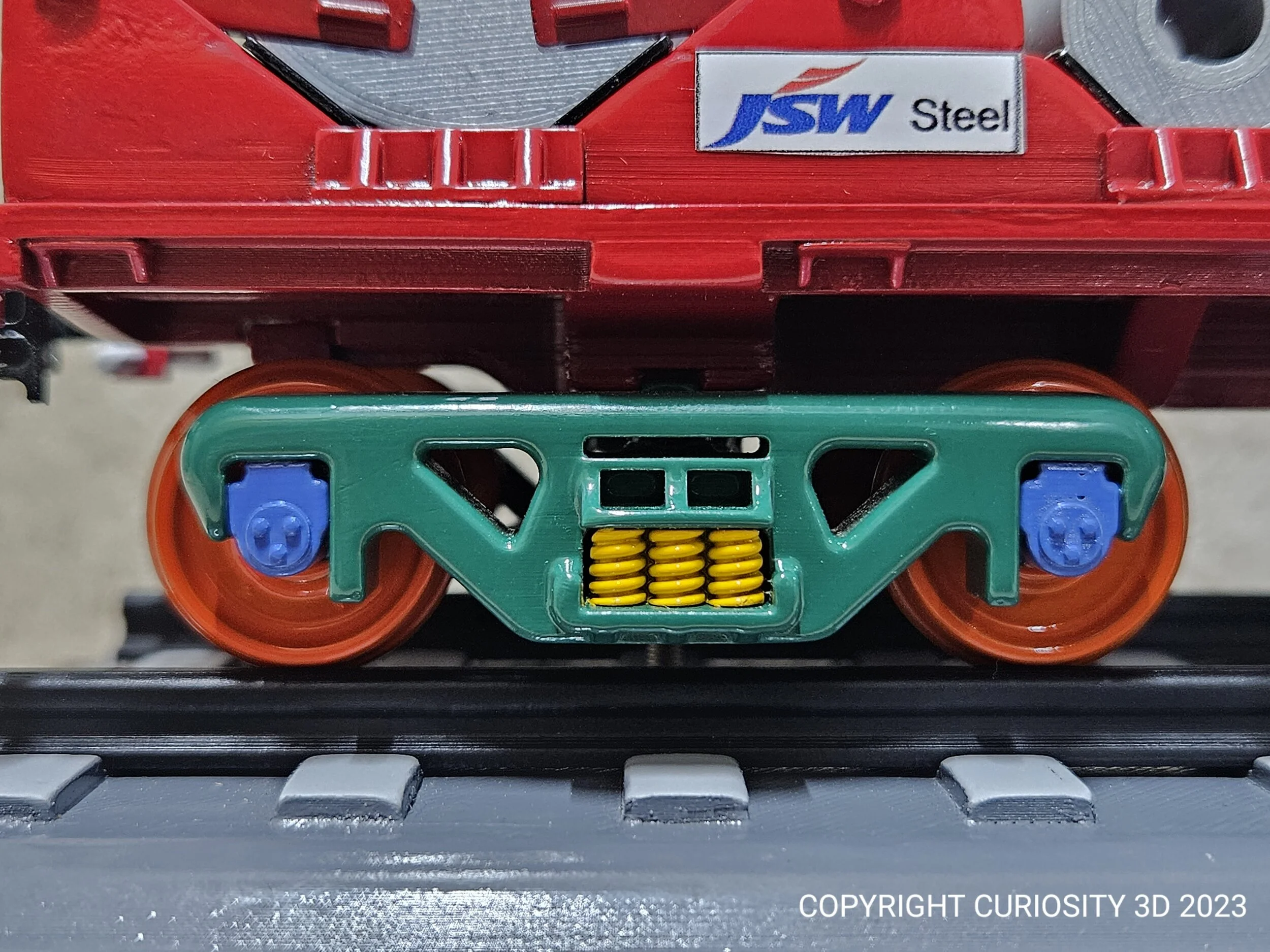 Toy train car with red body and green wheels