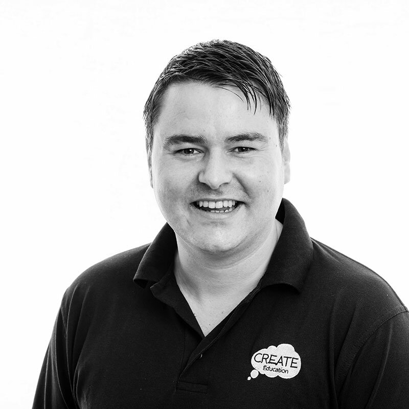 Smiling individual wearing a "CREATE Education" polo shirt.