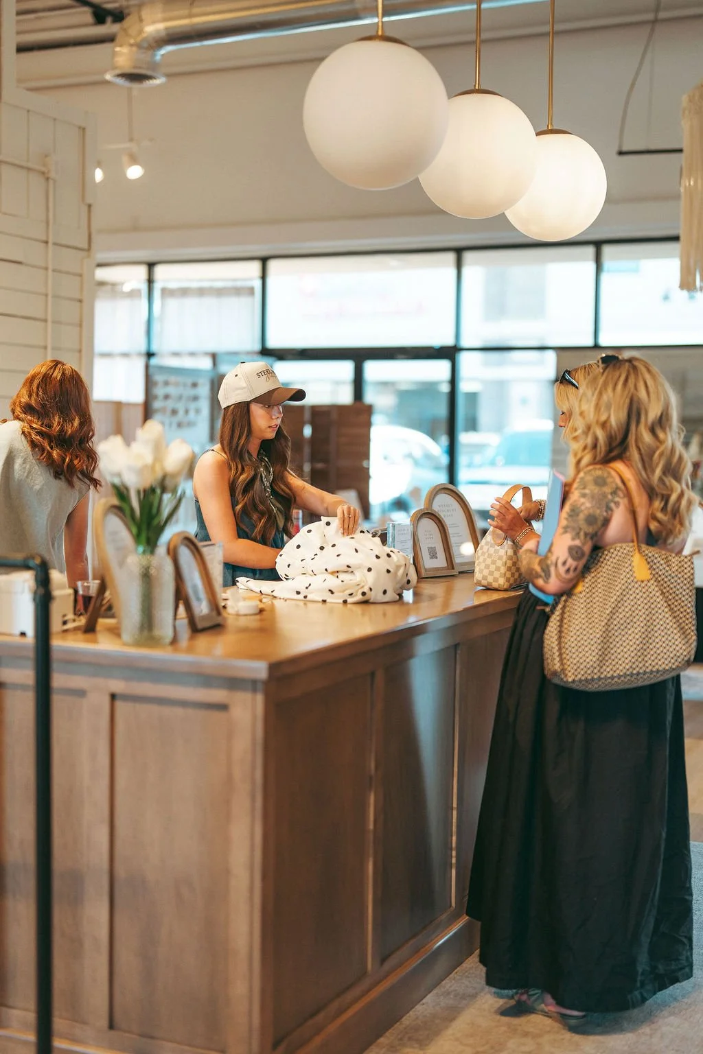 Women connecting at Highland Stables Social Club, a monthly girls night event series in Bowling Green, Kentucky focused on community and fun.