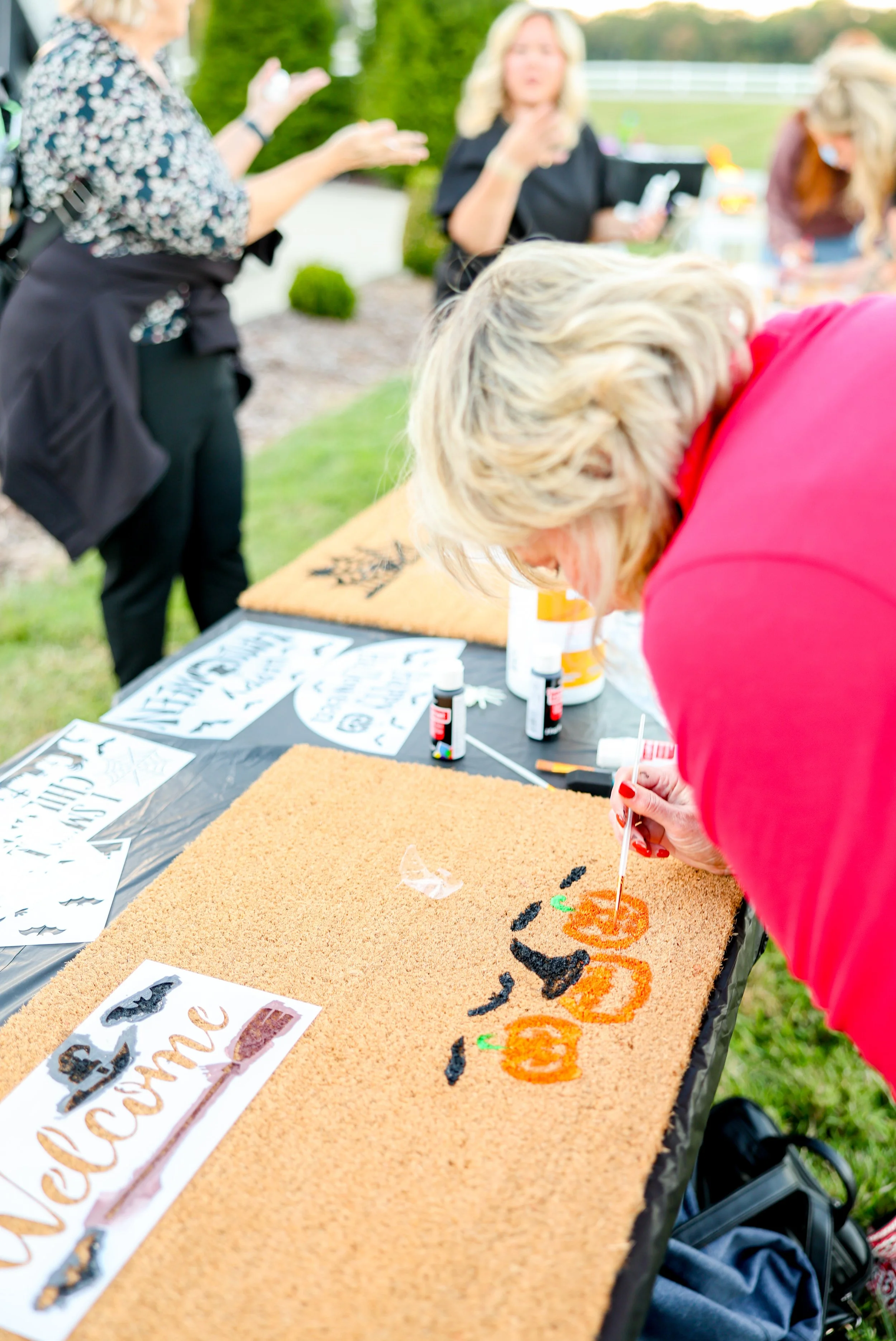 Women connecting at Highland Stables Social Club, a monthly girls night event series in Bowling Green, Kentucky focused on community and fun.
